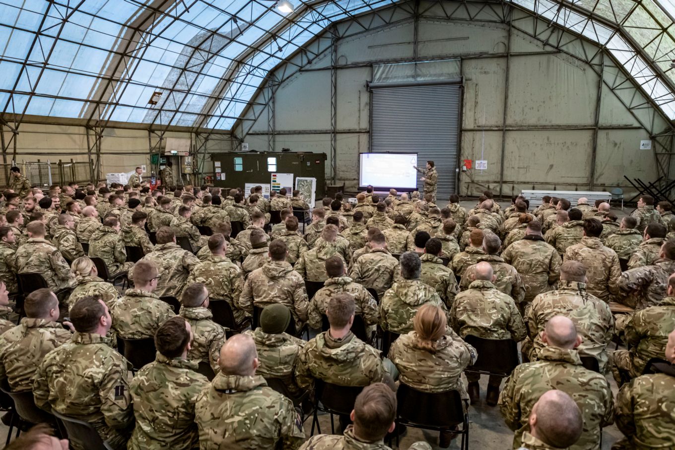 RAF personnel receiving briefing in hanger