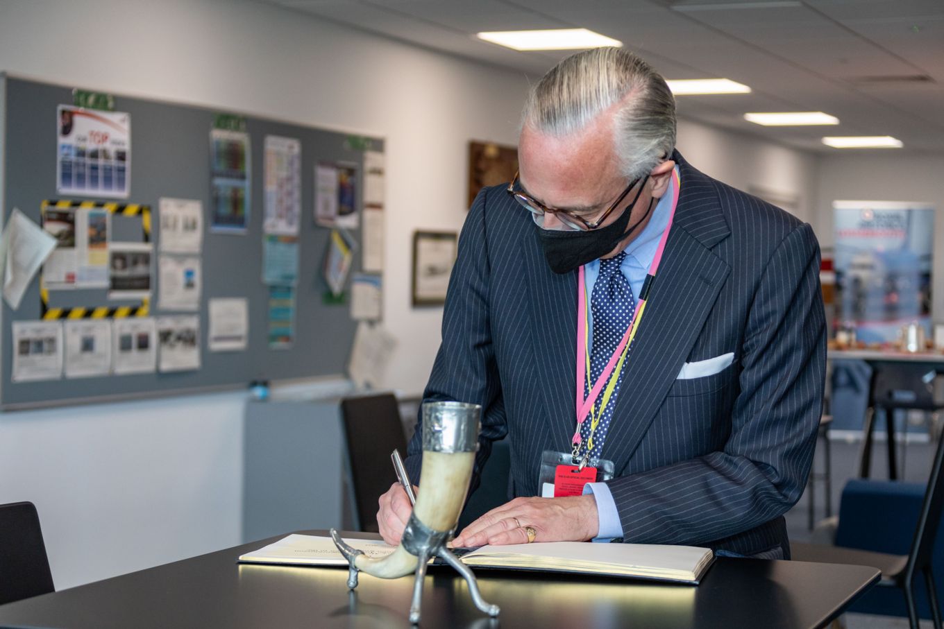 His Excellency Mr Sturla Sigurjónsson writing at a desk.
