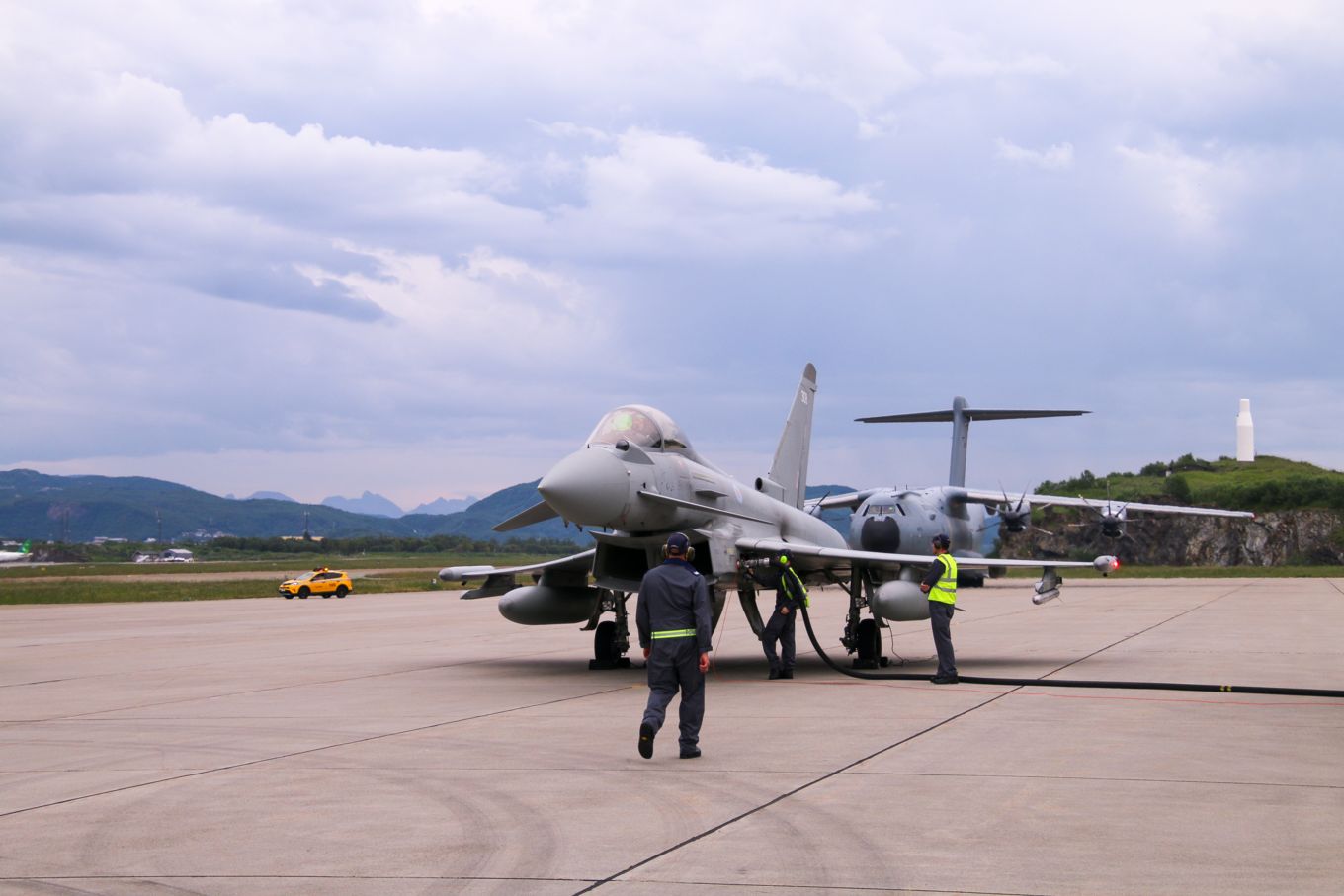 Typhoon aircraft being refuelled on the ground and A400M Atlas in the background.