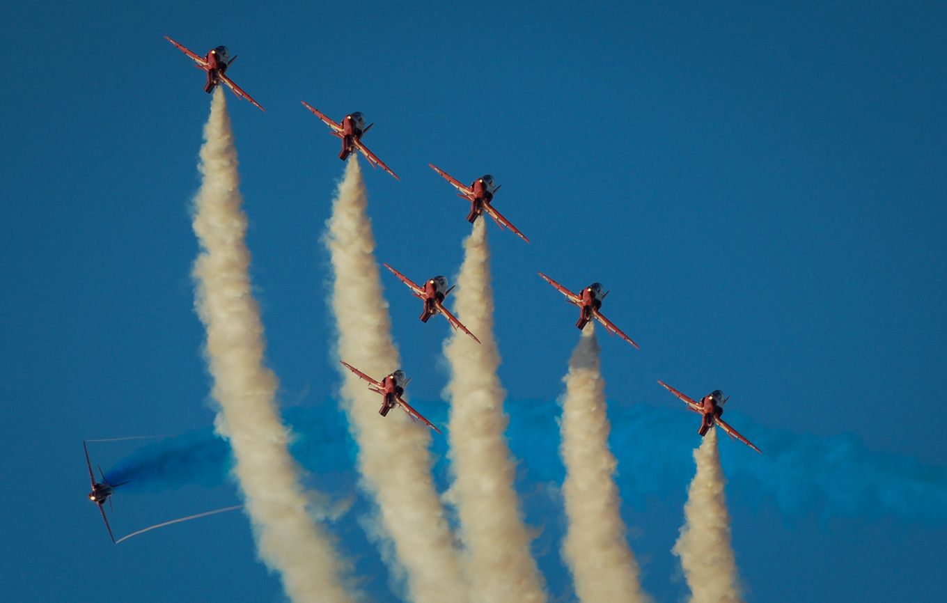Red Arrows in formation with smoke trails. 