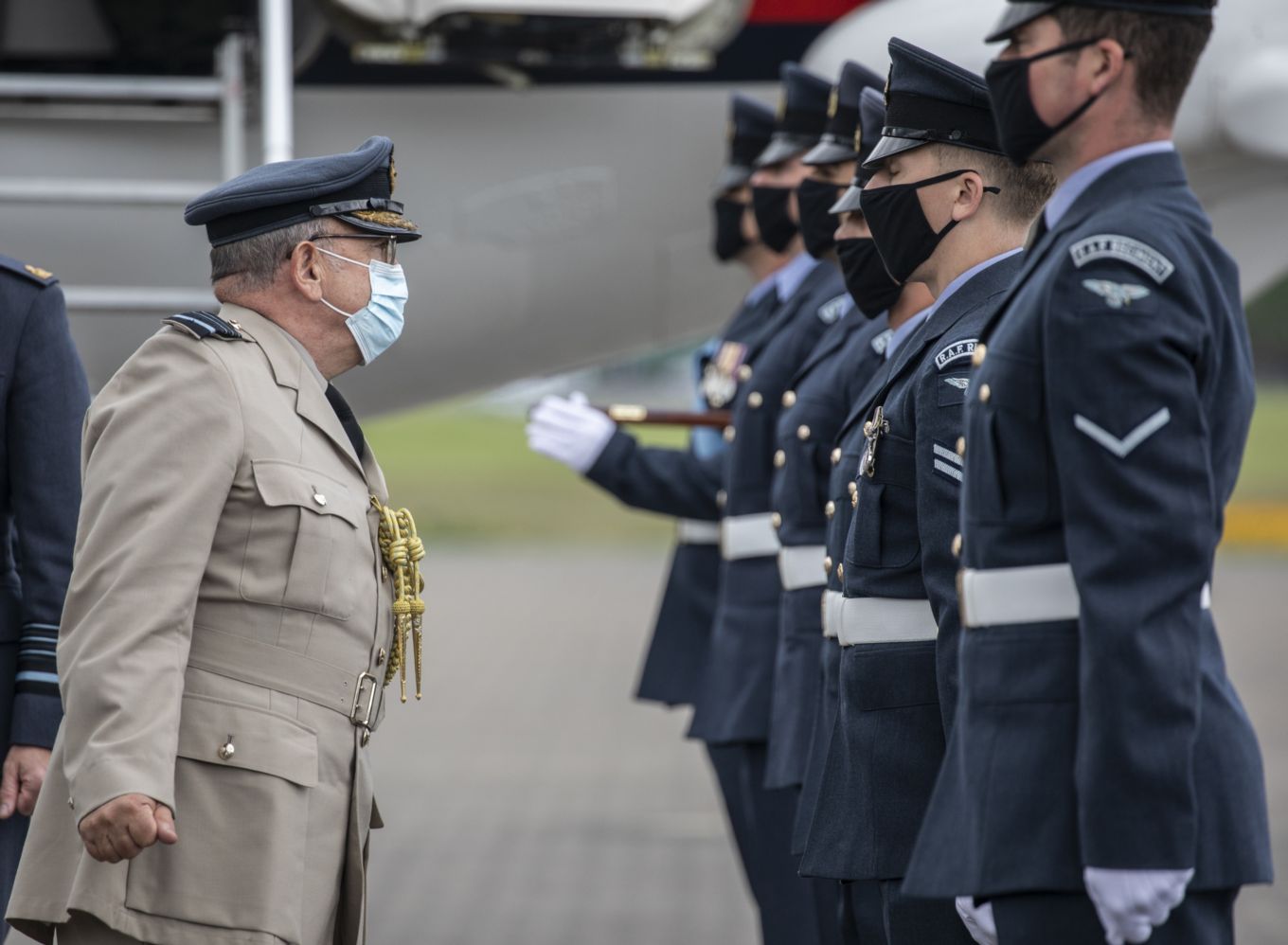 Air Chief Marshal Sir Stuart Peach with gathered personnel. Aircraft in background. 