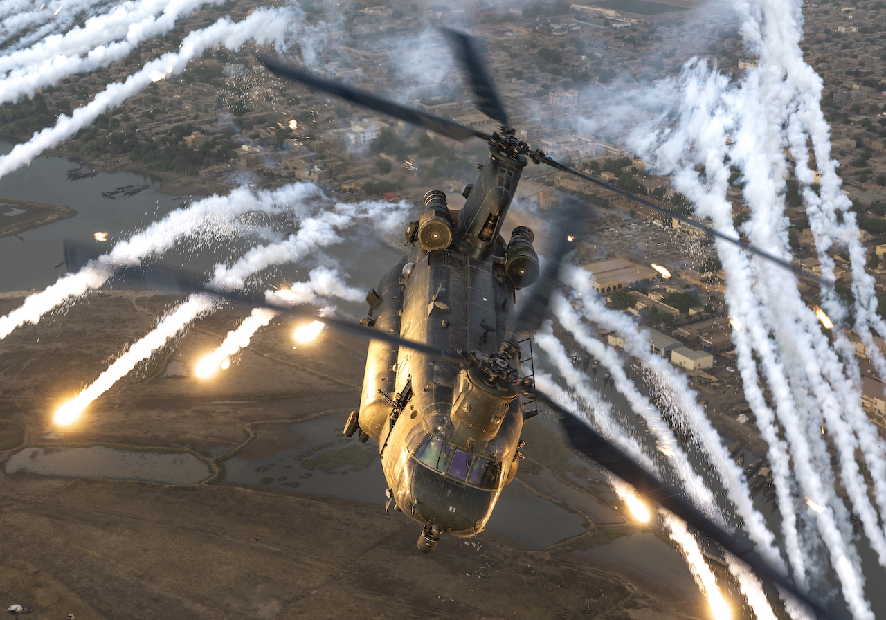 CH-47 Chinook flying through flares.