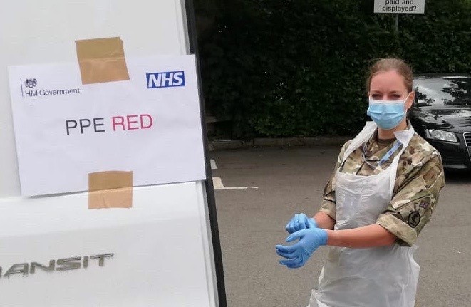 SAC Alice Noakes dons PPE at the mobile testing unit