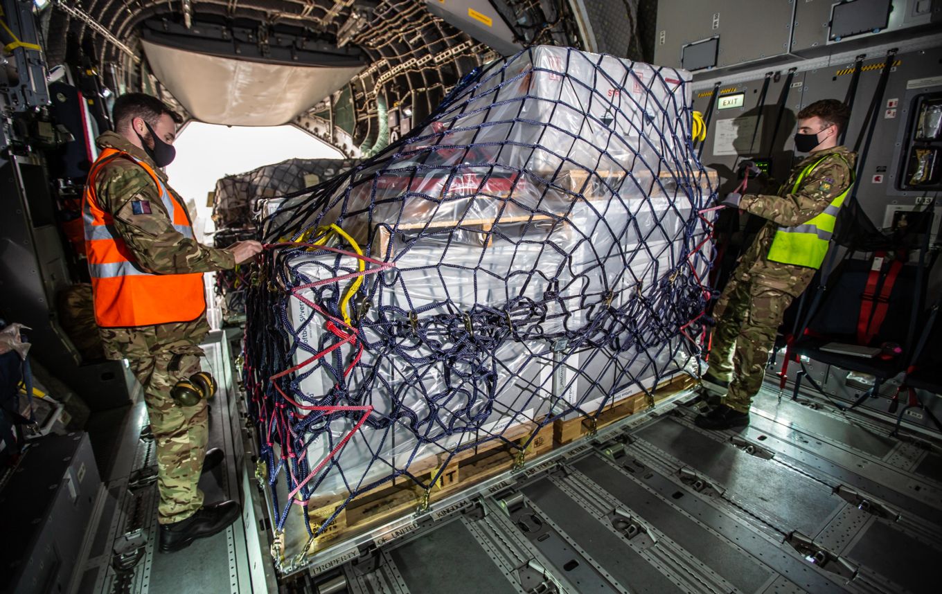 RAF personnel ensure the palletised load is secured safely on board the A400M Atlas