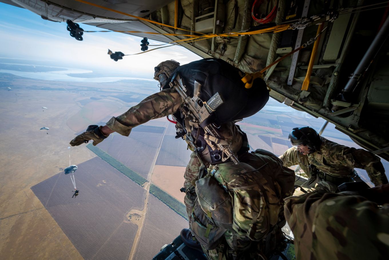A British Paratrooper from 16 Air Assault Brigade, prepares to jump from a C-130J Hercules