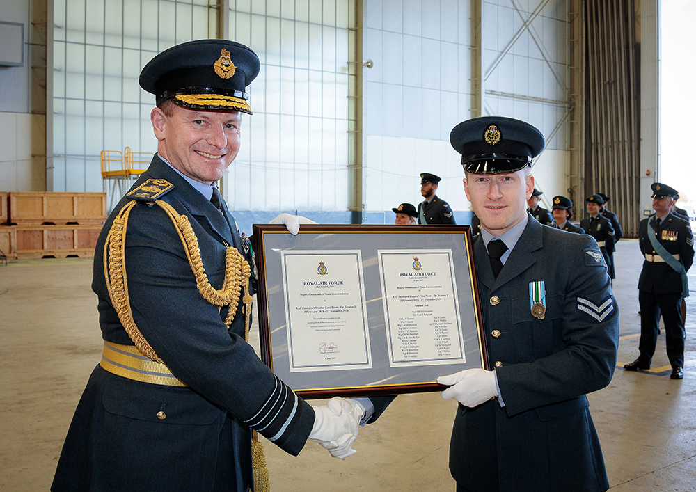 Chief of the Air Staff, Air Chief Marshal Wigston presents the Deputy Commander of Operations Team Commendation to Corporal Rigby