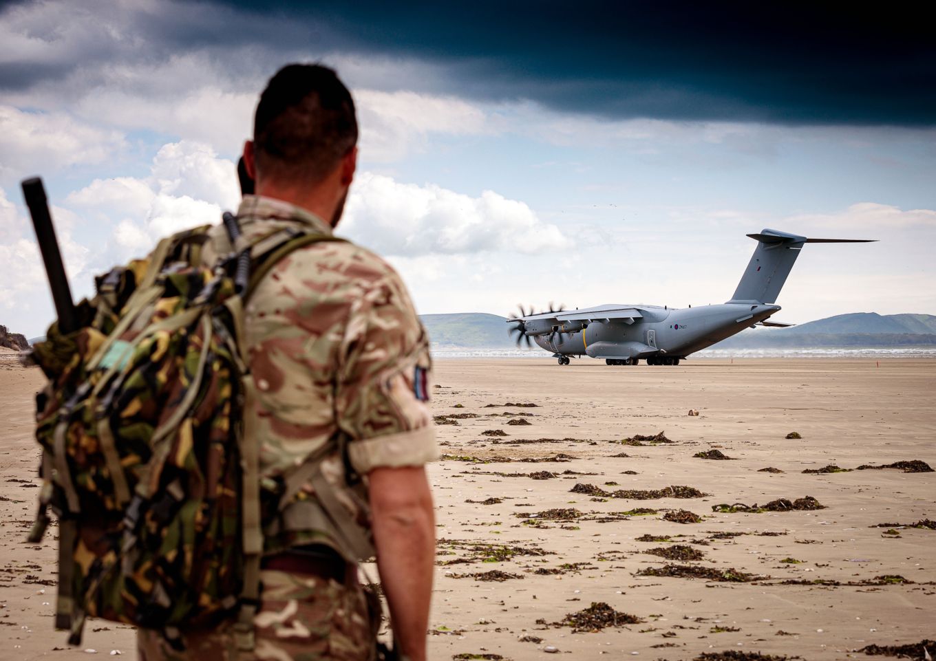 A member of Tactical Air Traffic Control facilitates the landing of the A400M Atlas onto the Tactical Landing Zone, Pembrey Sands