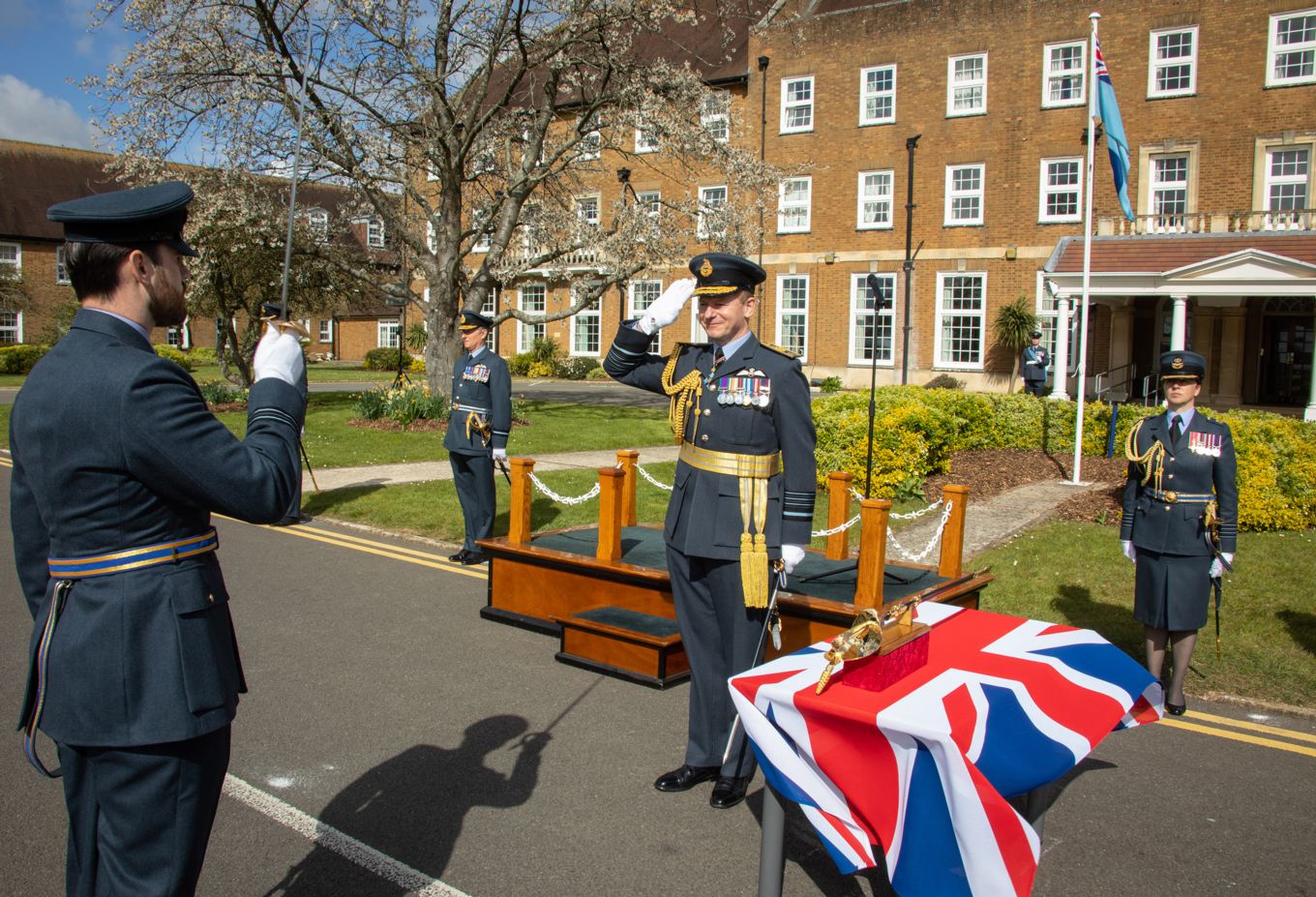 Flight Lieutenant Ben Burton, Parade Commander, salutes Chief of the Air Staff, Air Chief Marshal Sir Mike Wigston KCB CBE ADC, prior to receiving the Firmin Sword of Peace
