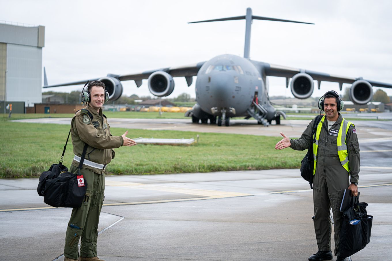 Number 99 Squadron Commander, Wing Commander Kev Latchman (right), formally welcomes Captain Craig Hughes of the Royal Canadian Air Force (RCAF)
