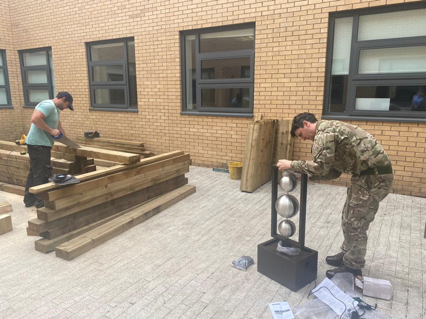 Work in Progress – ‘All hands to the deck’ to make the garden relaxing and welcoming with bespoke wooden benches and a water feature