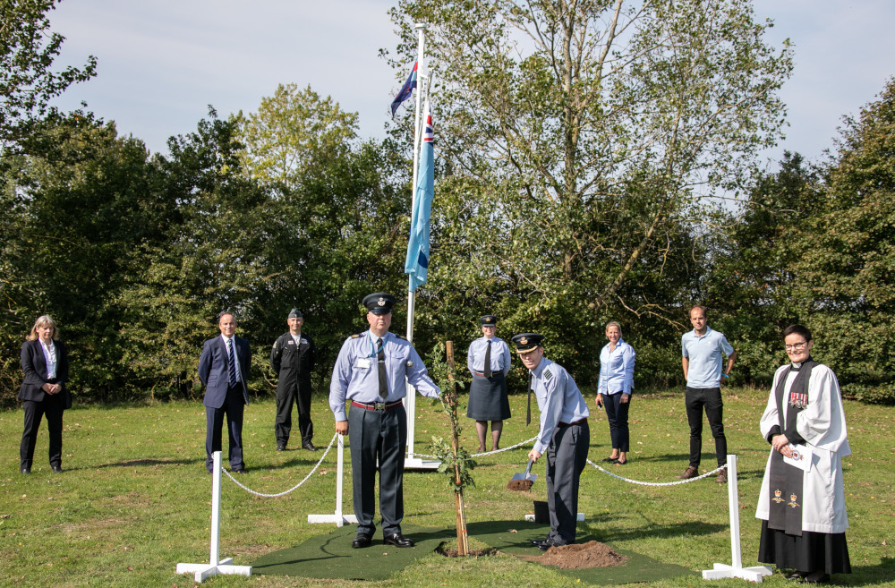 Station Commander with representatives from BAE Systems, The Woodland Trust, and Lincolnshire County Council as he plants the first of 80 memorial trees.