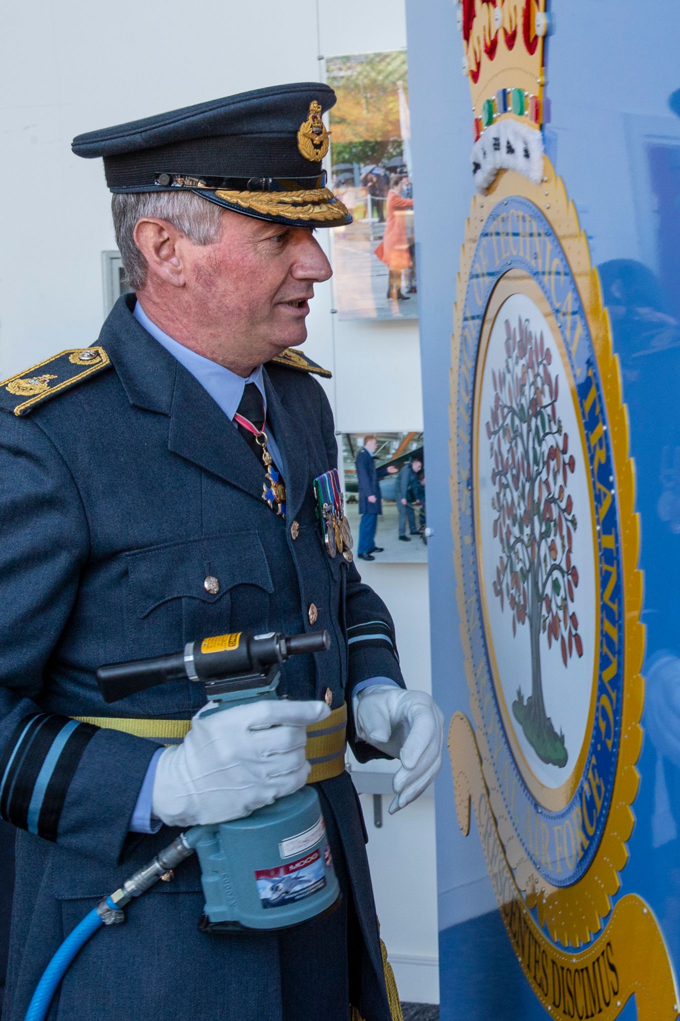 AVM Bethall putting the first rivet on the board