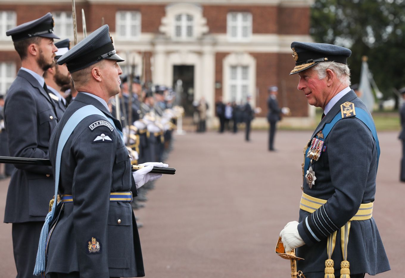 Image shows HRH, The Prince of Wales meeting Graduating Officers with the College Warrant Officer