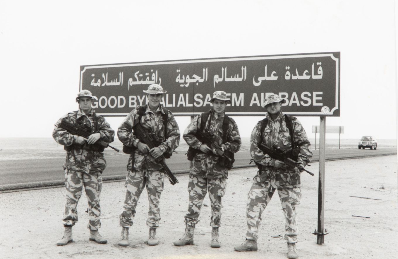 Feb 1991. Members of 1 Sqn pose near a road sign near the recently re-captured Ali Al Salem Air Base, Kuwait