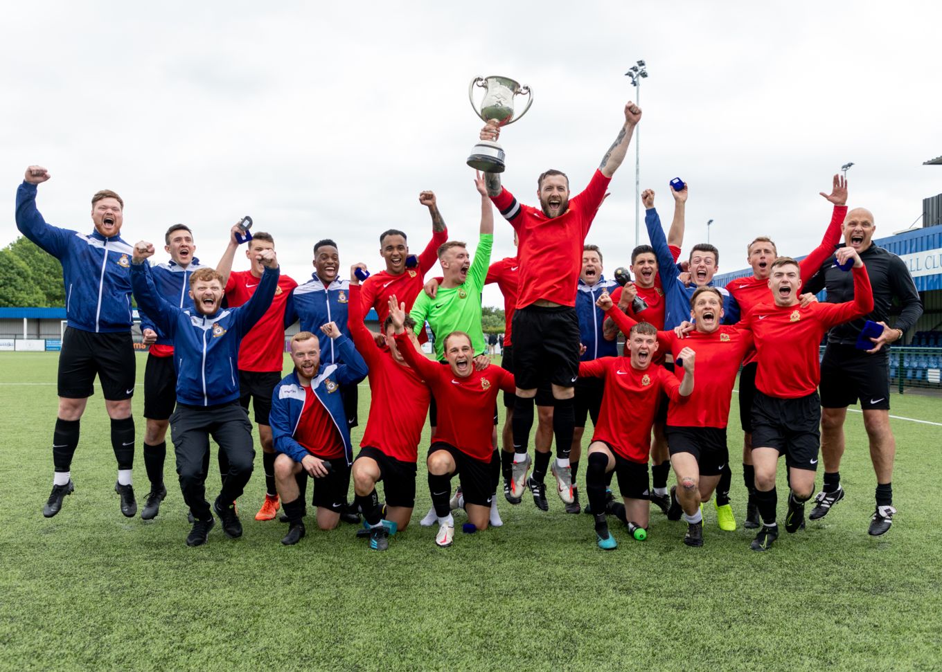 RAF Honington Football Team celebrate with the Keith Christie Trophy