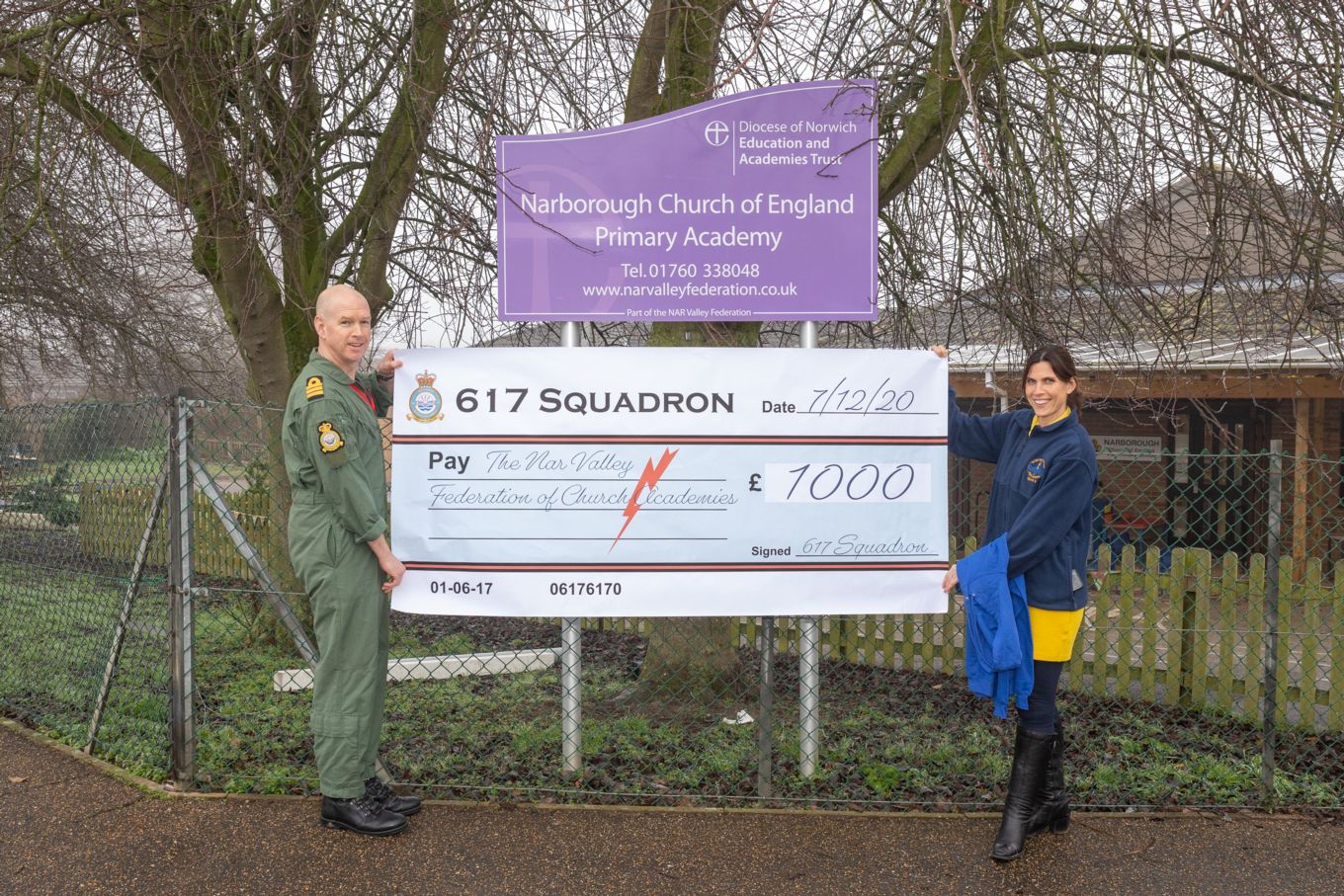 Handover of the giant cheque for £1000 in front of Narborough Primary School