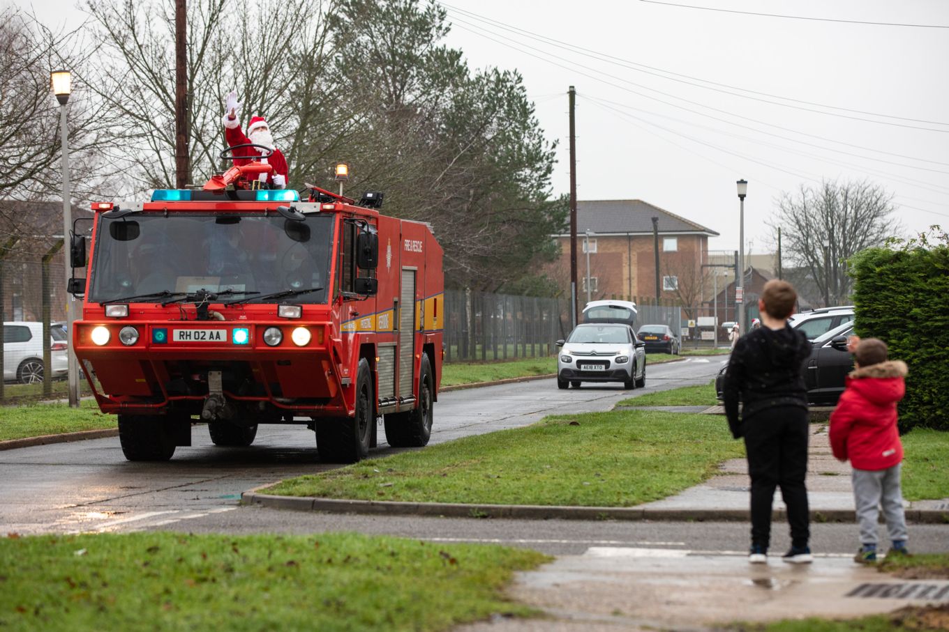 Santa on a fire engine delivering presents