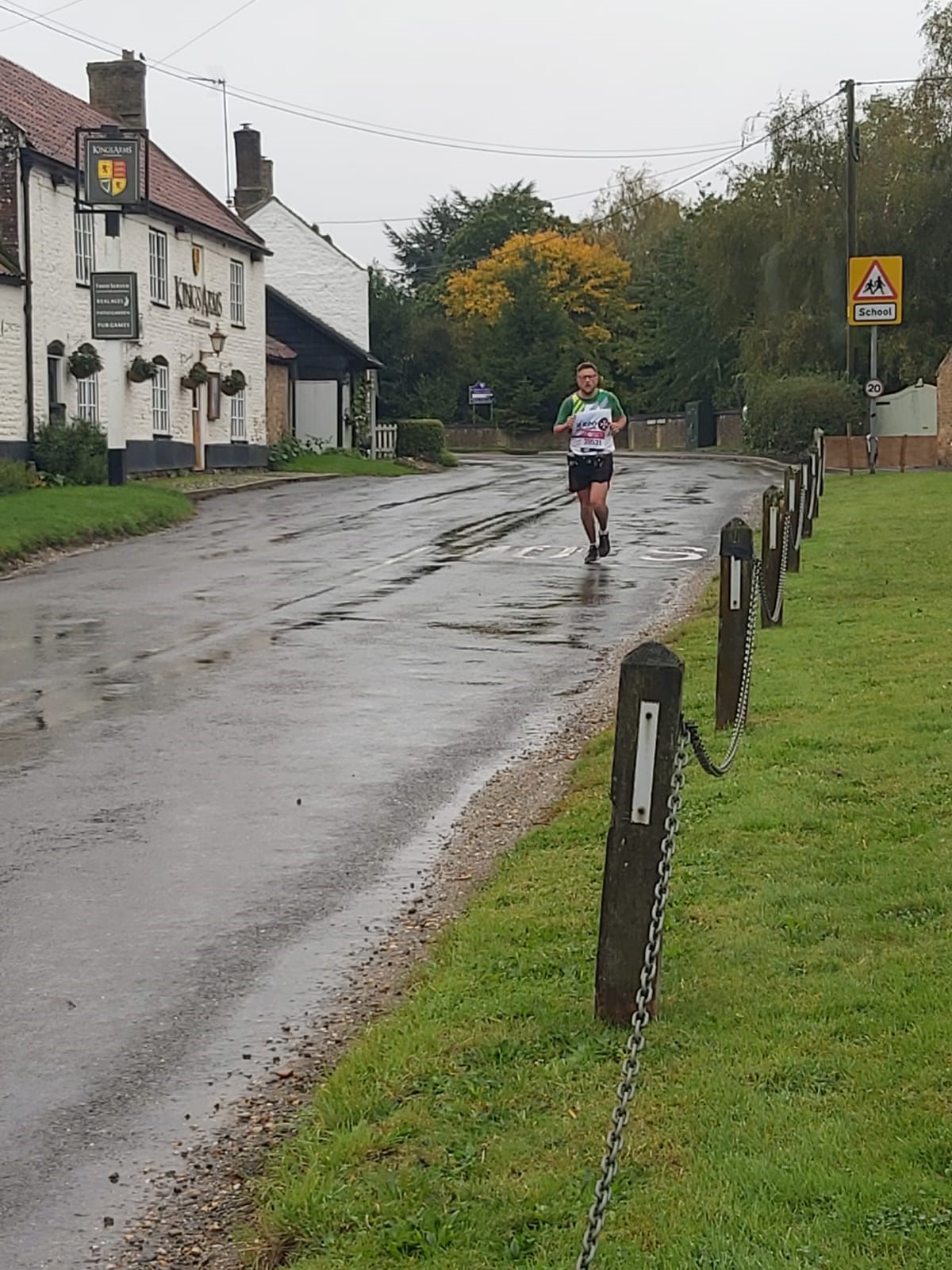 Cpl Dungay running through local village