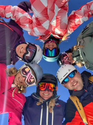 A group of skiers pose for the camera.