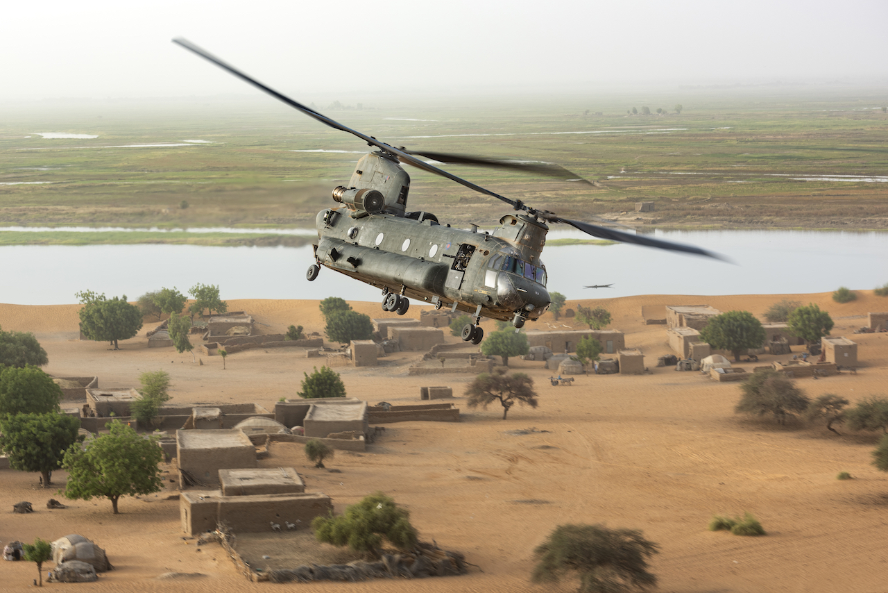 RAF Chinhook flying over a village
