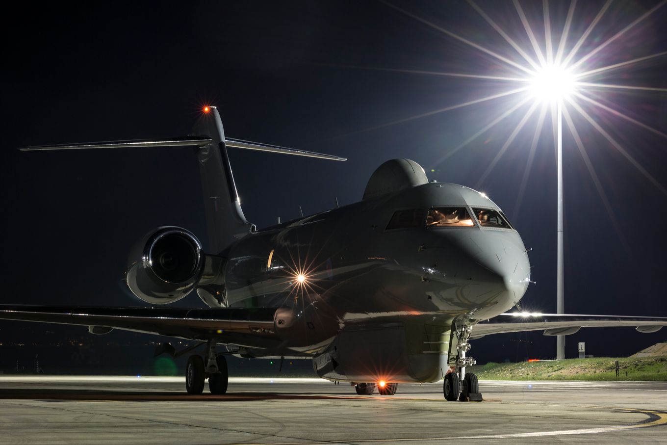 Image shows an RAF Sentinel R1 aircraft on the ground at night.
