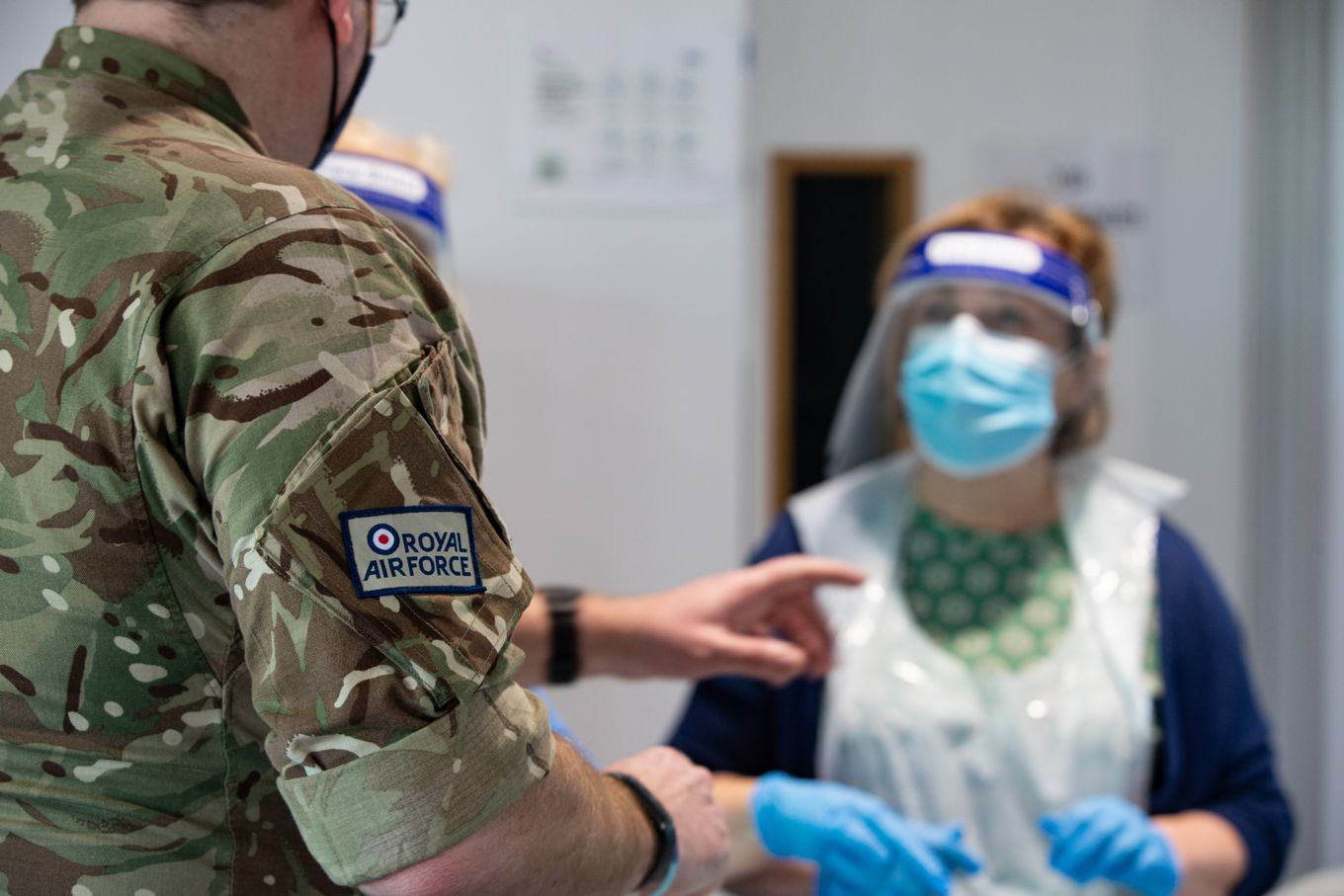 The RAF Team Leader, Corporal Anthony Burnham-Bamford, in conversation with a member of the school staff