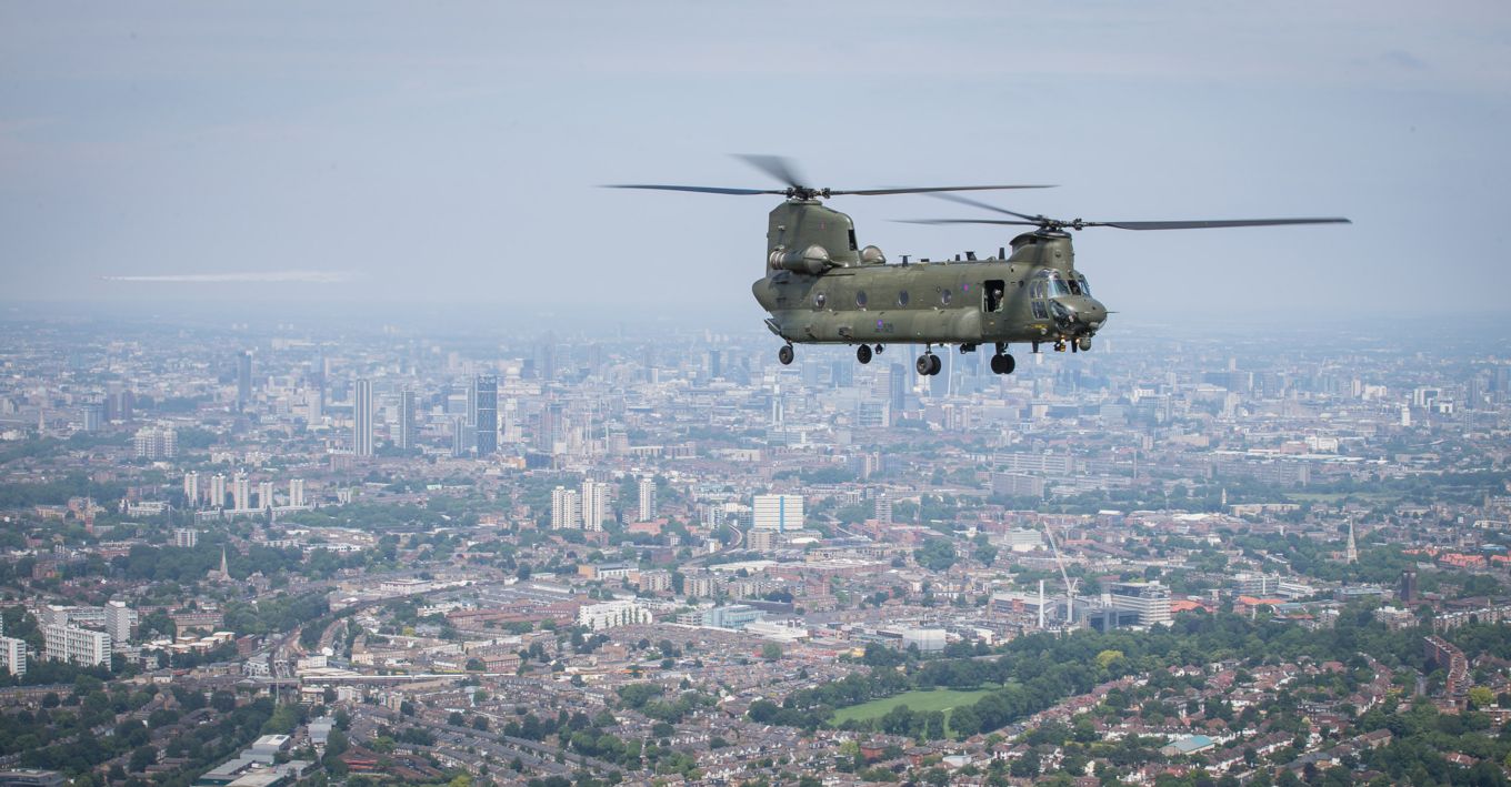 Chinook flying over an urban built up area