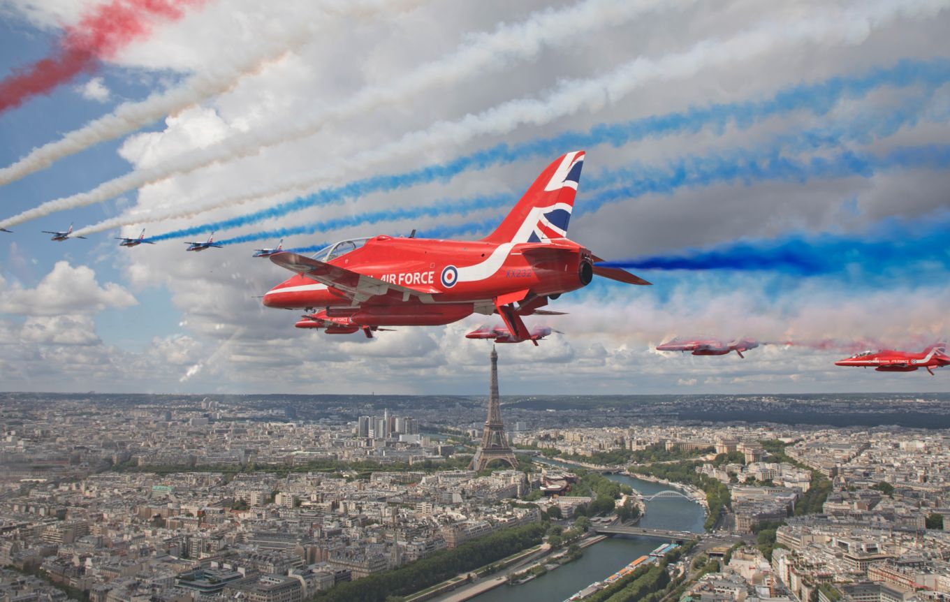 The Red Arrows over Paris with the Eiffel Tower in the distance.