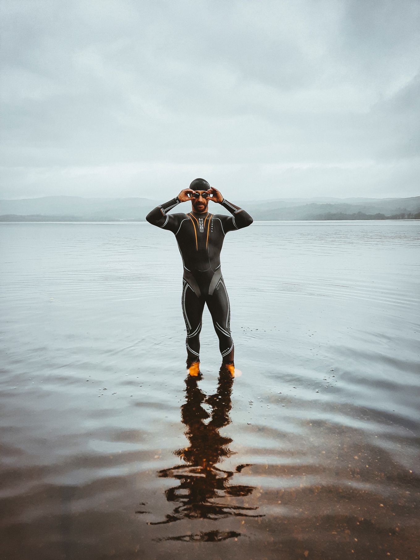 Frankie in a wetsuit swimming in a lake. 