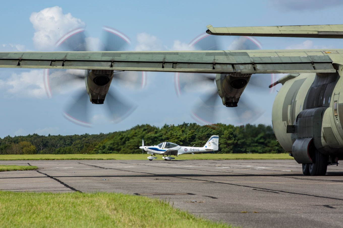 The airfield at RAF Wittering during Exercise Swift Pirate. The image shows an RAF C130 Hercules and a Grob 115E Tutor aircraft