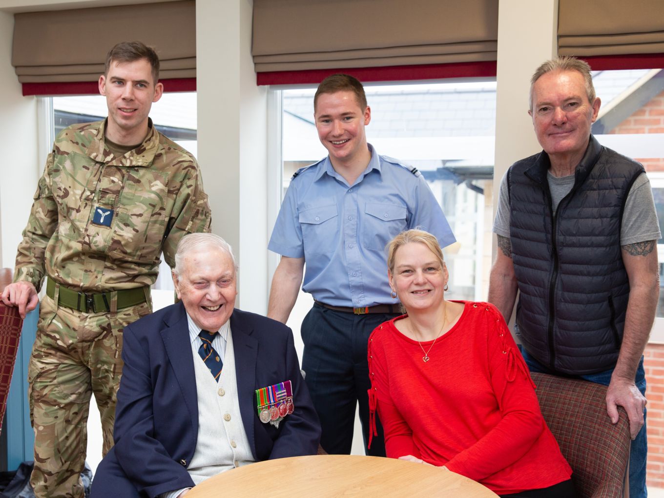 Mr James Fay (seated left) and family with Flying Officer Ryan Johnson (standing centre)
