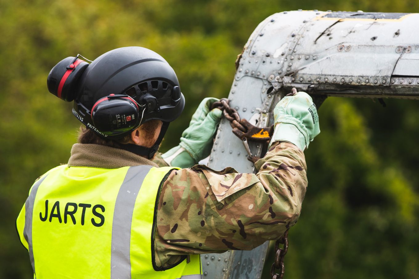 A member of the JARTS teams secures the helicopter fuselage before lifting