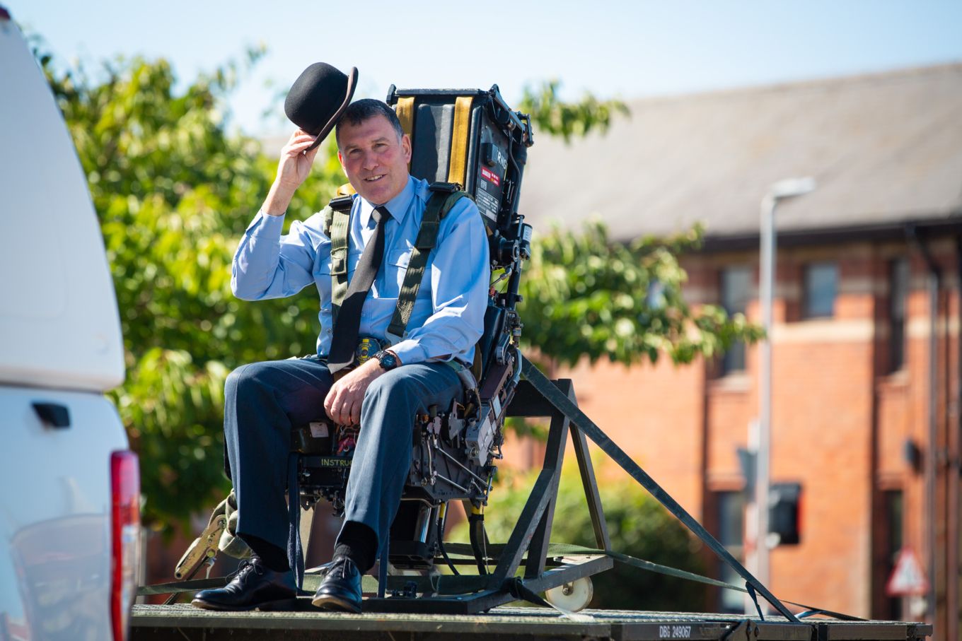 Warrant Officer Coates raises the traditional bowler hat as he leaves regular RAF service