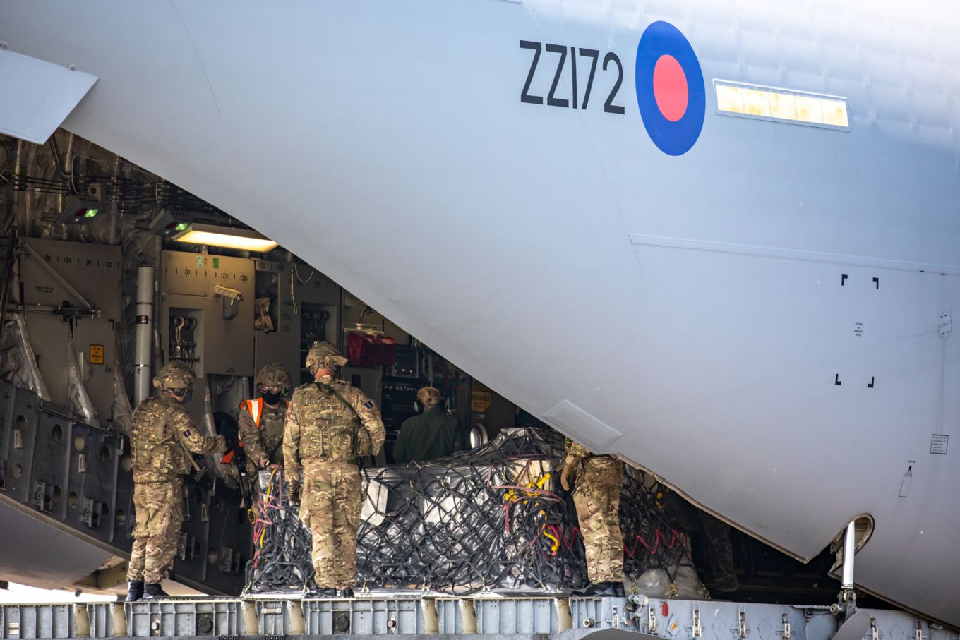 The team from No 1 Air Mobility Wing loading humanitarian cargo onto a C-17 Globemaster.