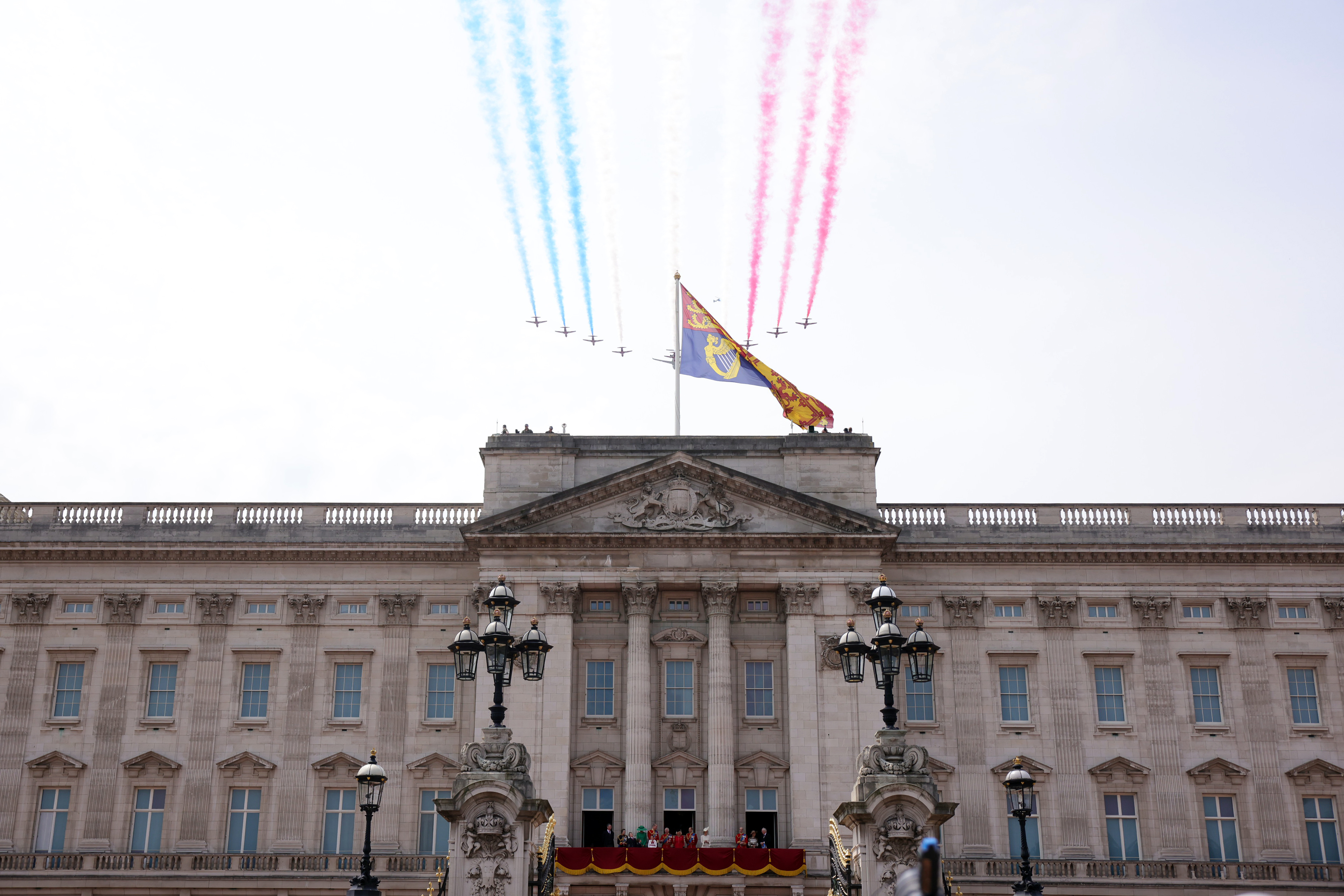 Image shows the Red Arrows flying over Buckingham Palace.