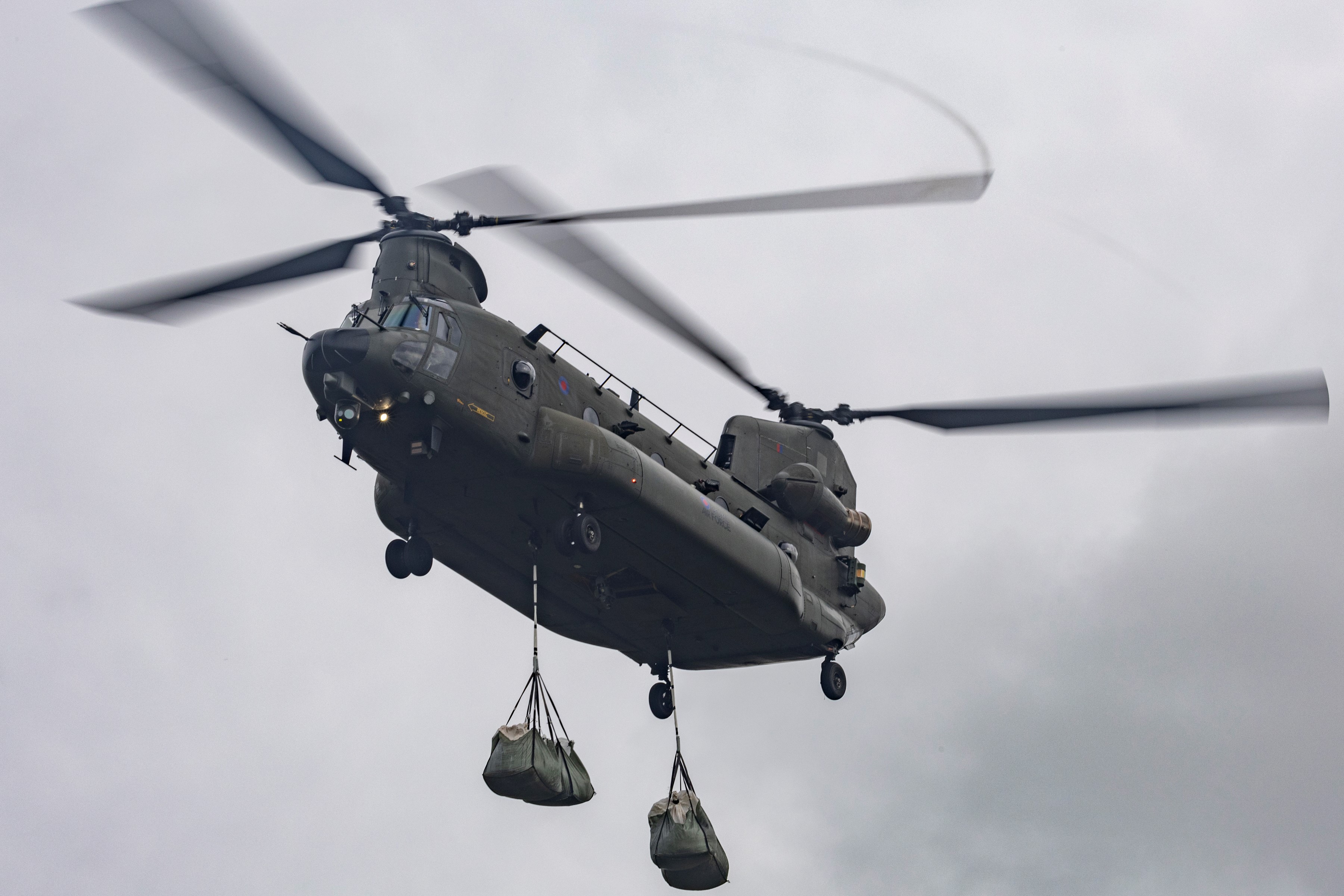 Chinook flying overhead with the chalk load under slung