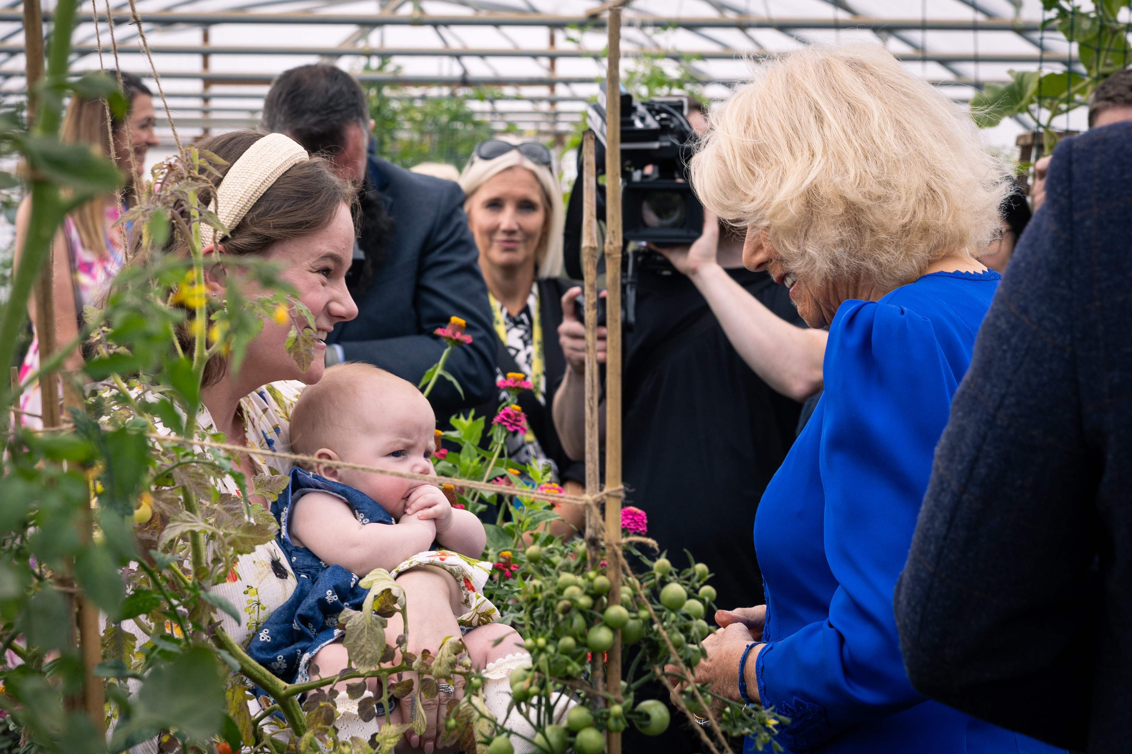 Her Majesty the Queen meets a mother and baby