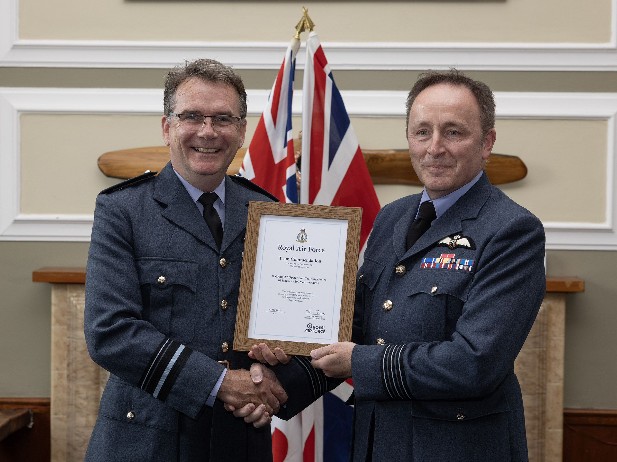 Wing Commander Si Reade, Officer Commanding OTC is presented with the commendation by Air Vice-Marshal Tom Burke CBE