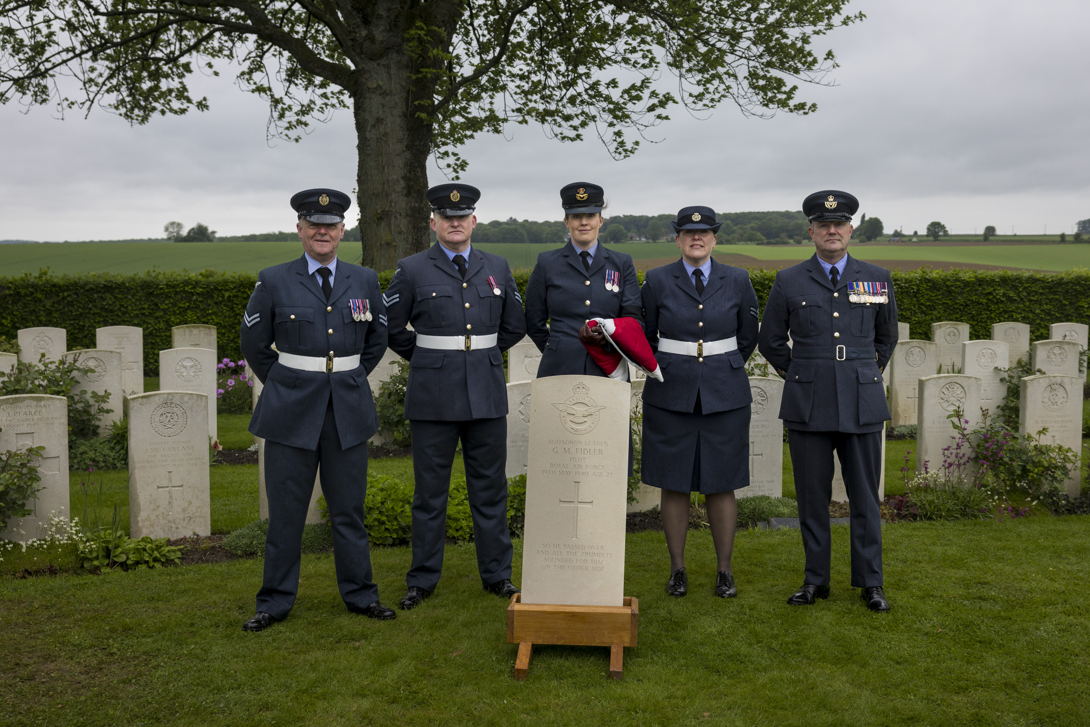 Personnel from 607 Co of Durham Sqn with the gravestone which will mark Sqn Ldr Fidler's final resting place