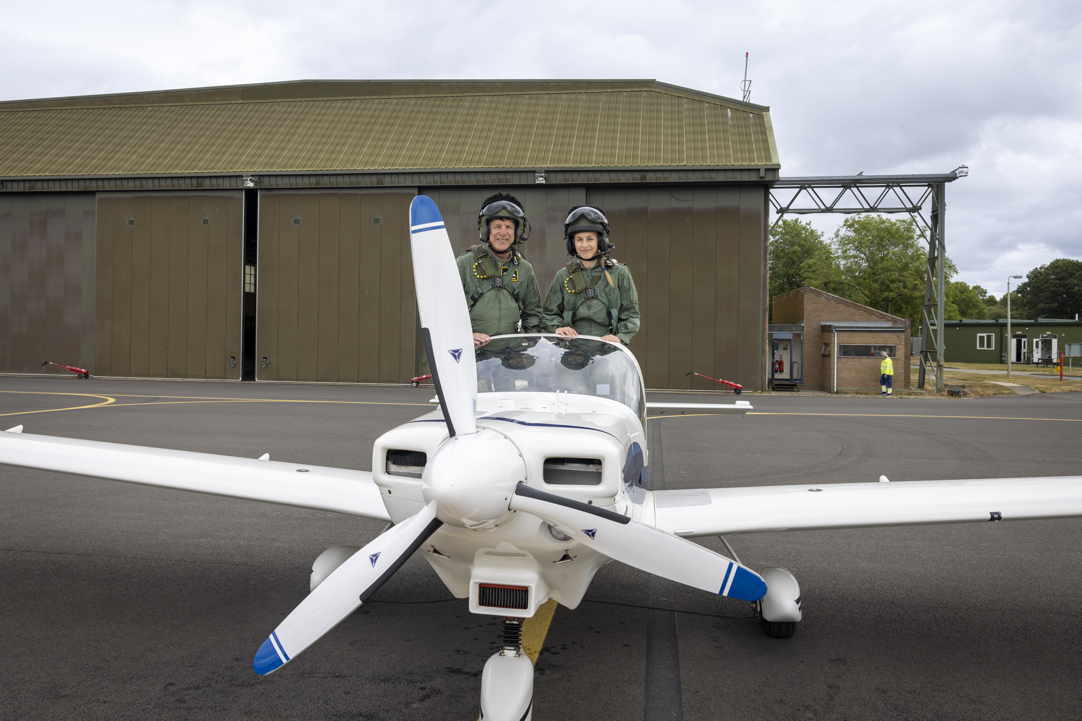 Flt Lt James and Cadet daughter Emily sit atop a tutor aircraft