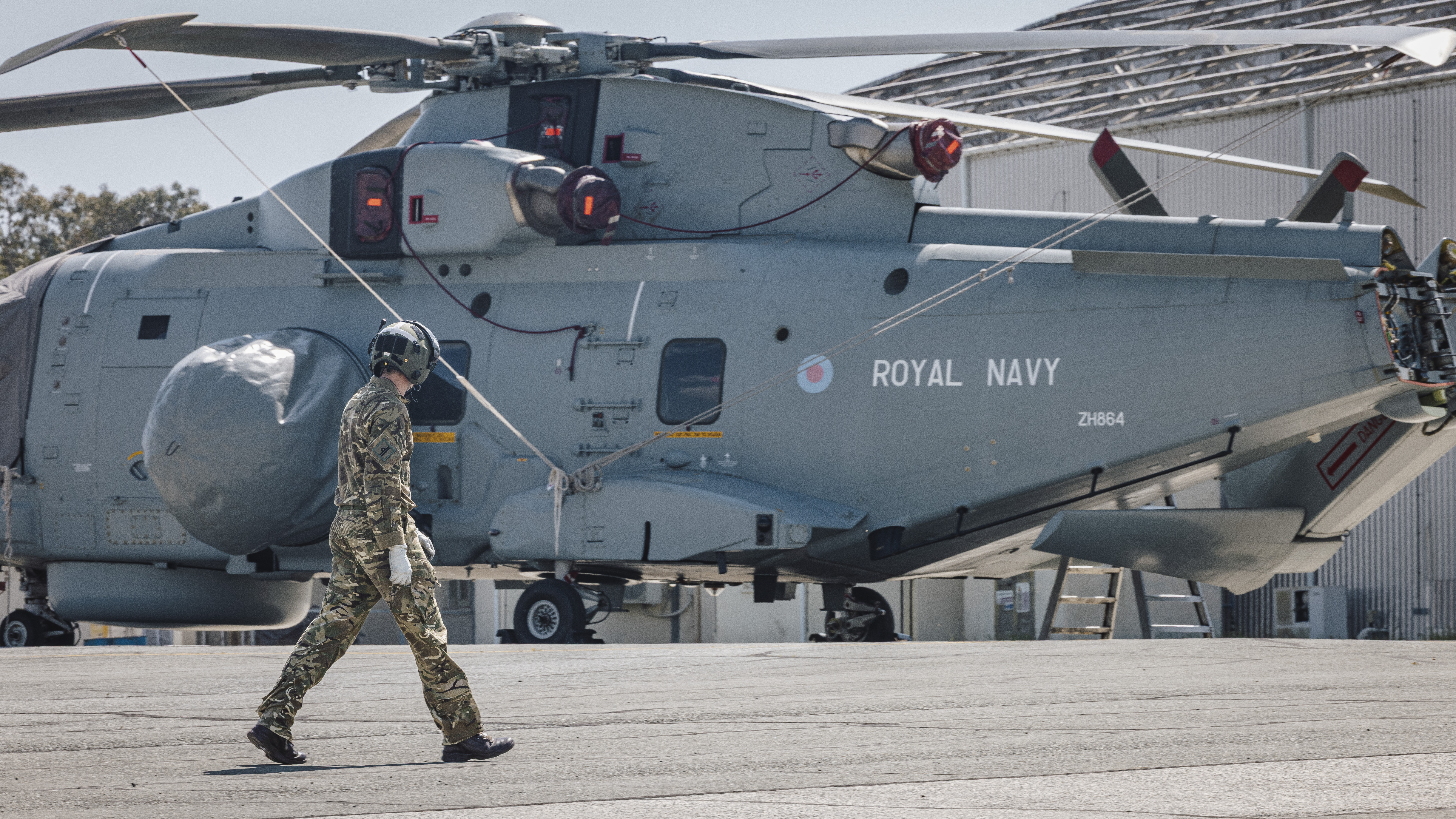 A Royal Navy Merlin helicopter on the runway.