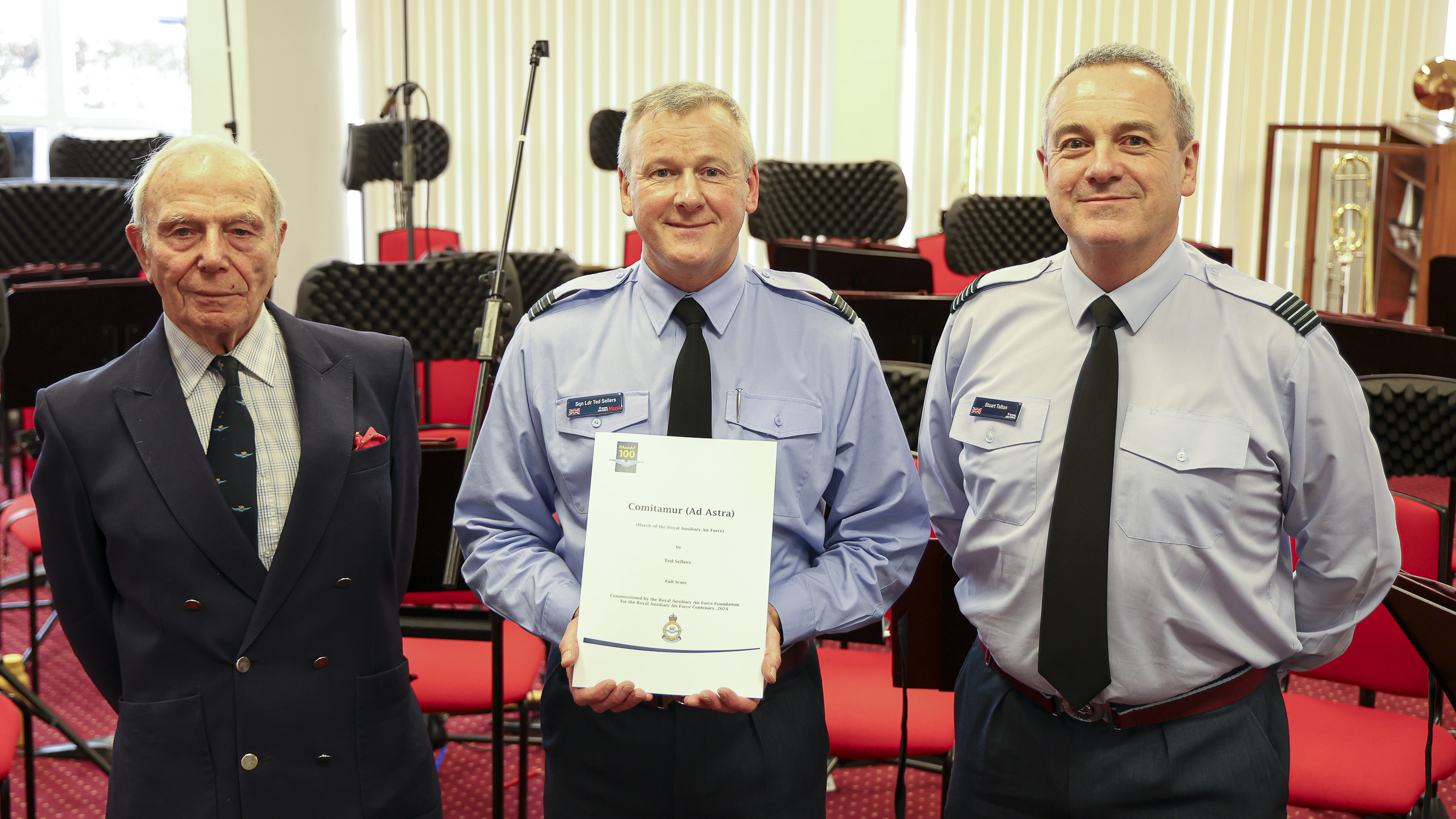 Squadron Leader Sellers, Director of Music Band of the RAuxAF, gives a presentation copy of the score to Group Captain Richard Mighall OBE (Retd) – Chairman of the RAuxAF Foundation and Wing Commander Stuart Talton QVRM - Dept Inspector RAuxAF