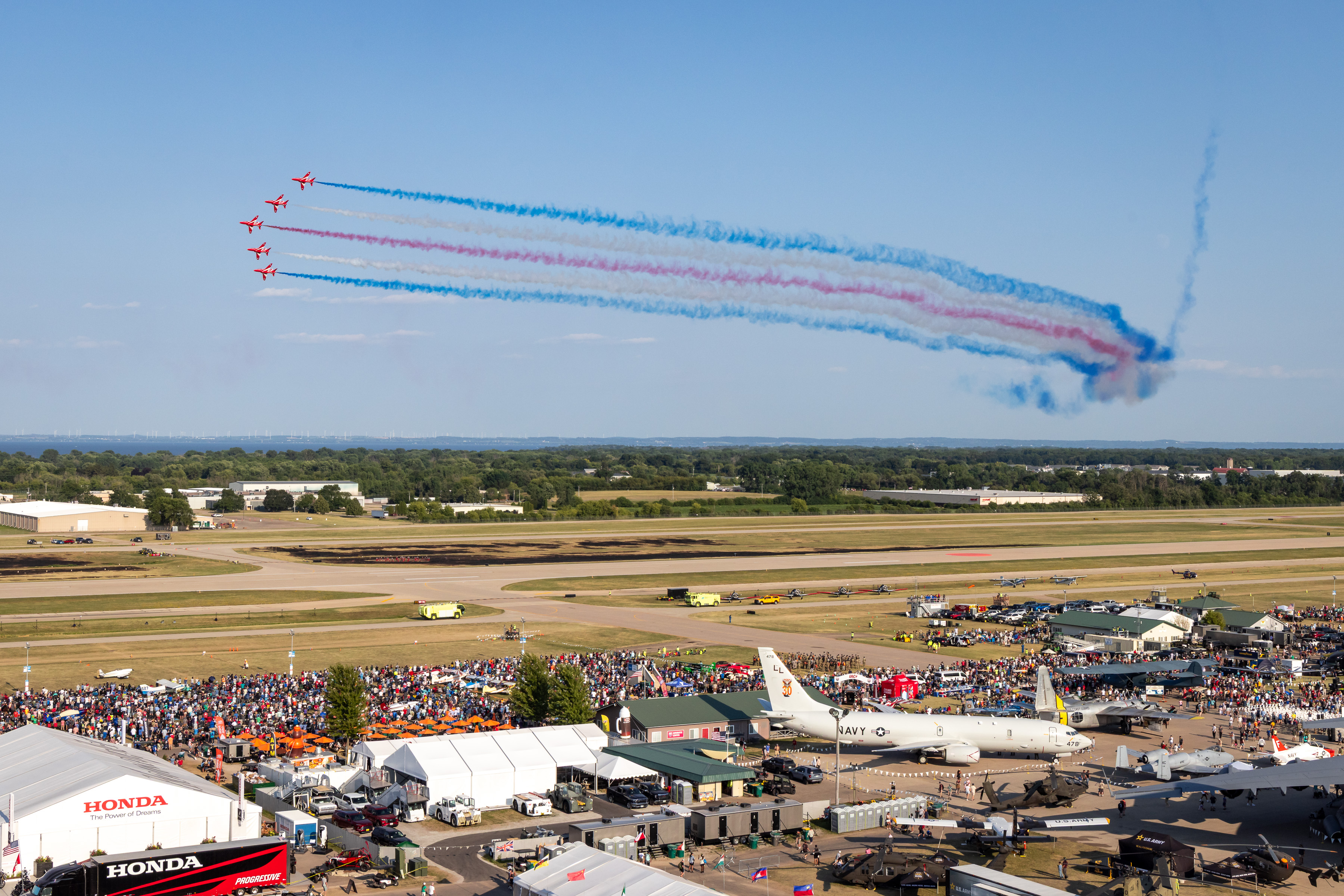The Red Arrows' trademark colours trailing in a display over Oshkosh - the world's biggest aviation gathering.