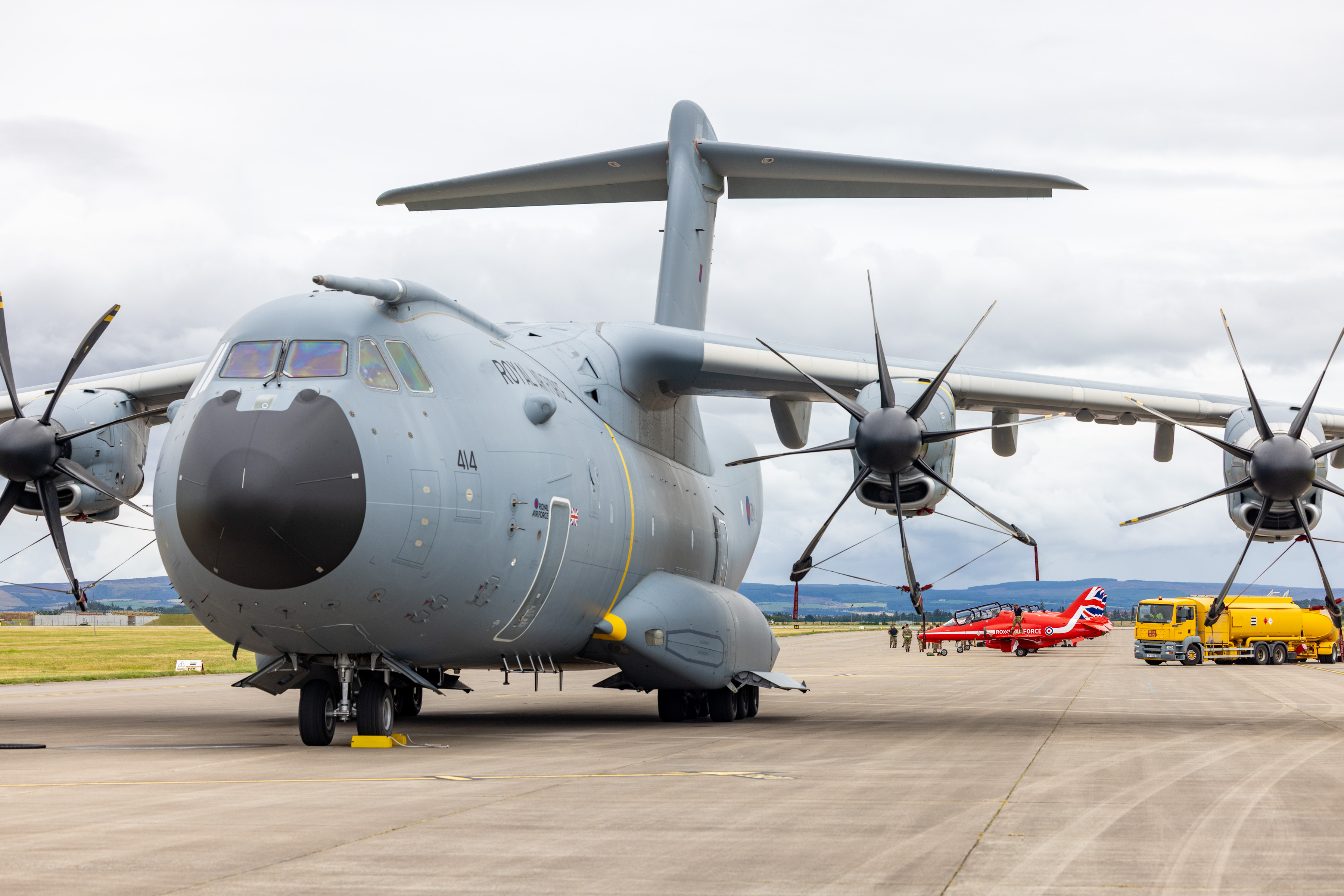 An A4000M Atlas, with the Red Arrows behind, is seen parked at RAF Lossiemouth during the return trail.