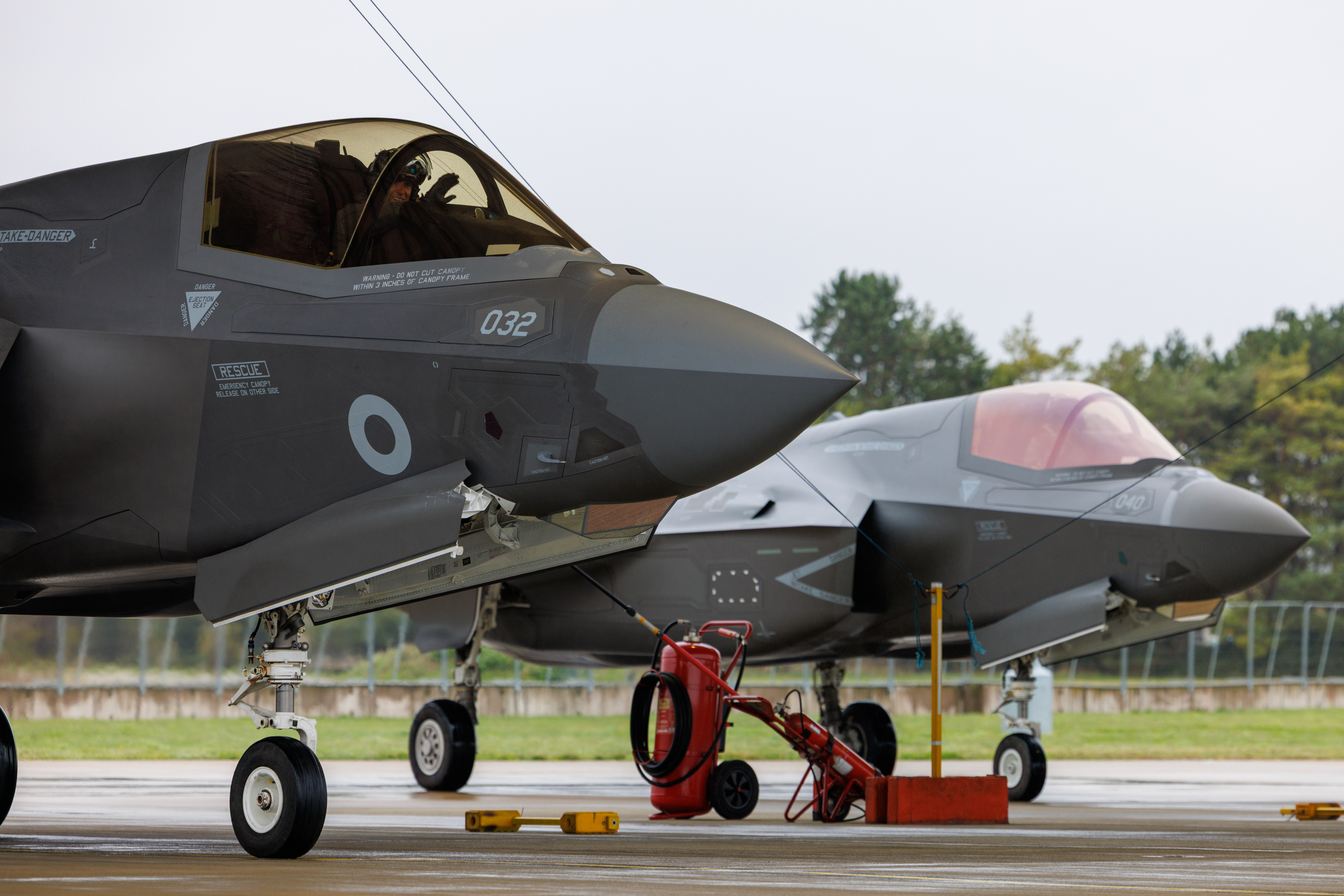 British F35s on the runaway after arriving back in Britain. A pilot waves from the cockpit.