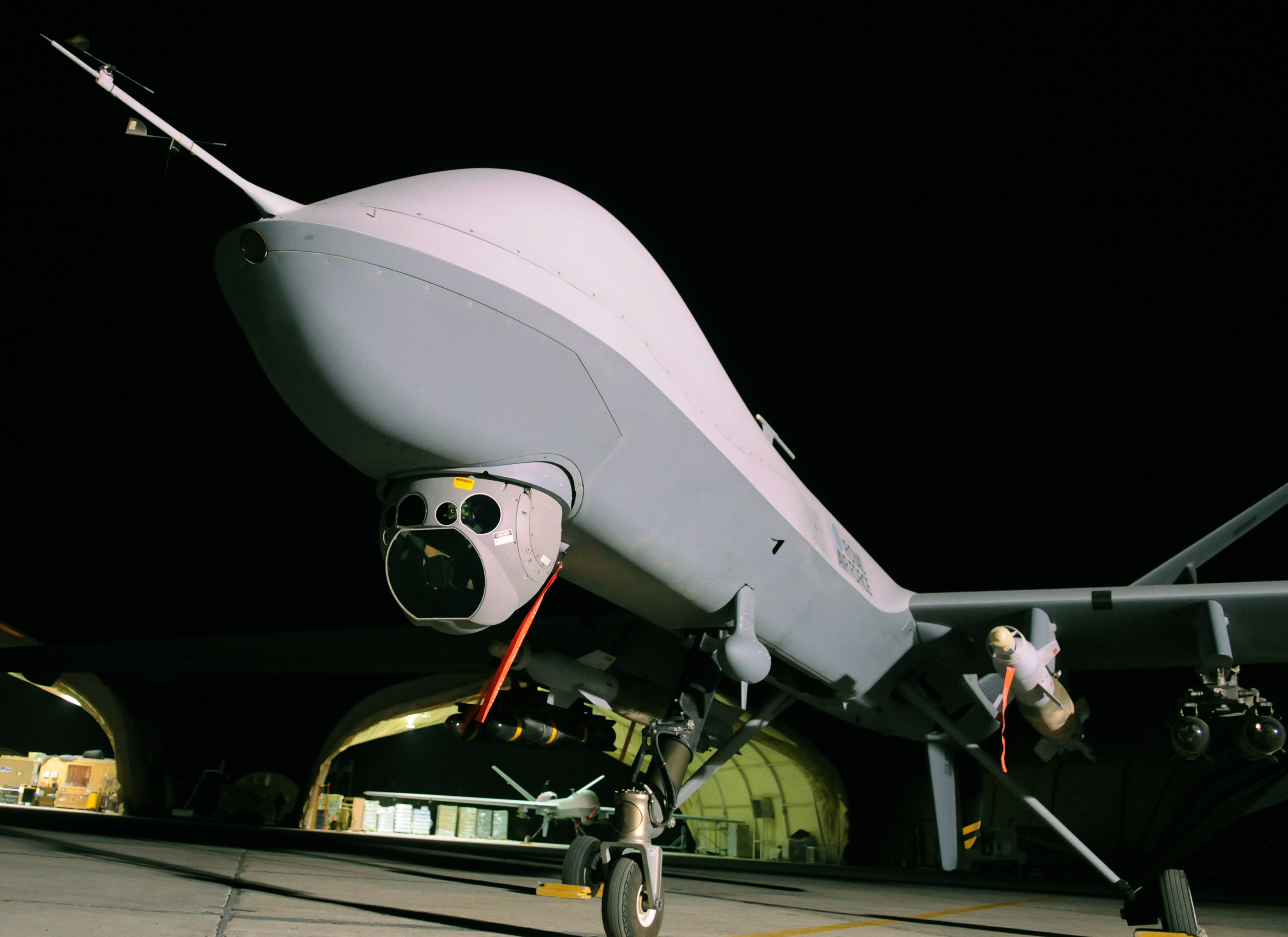 An RAF Reaper pictured on a runway at night.