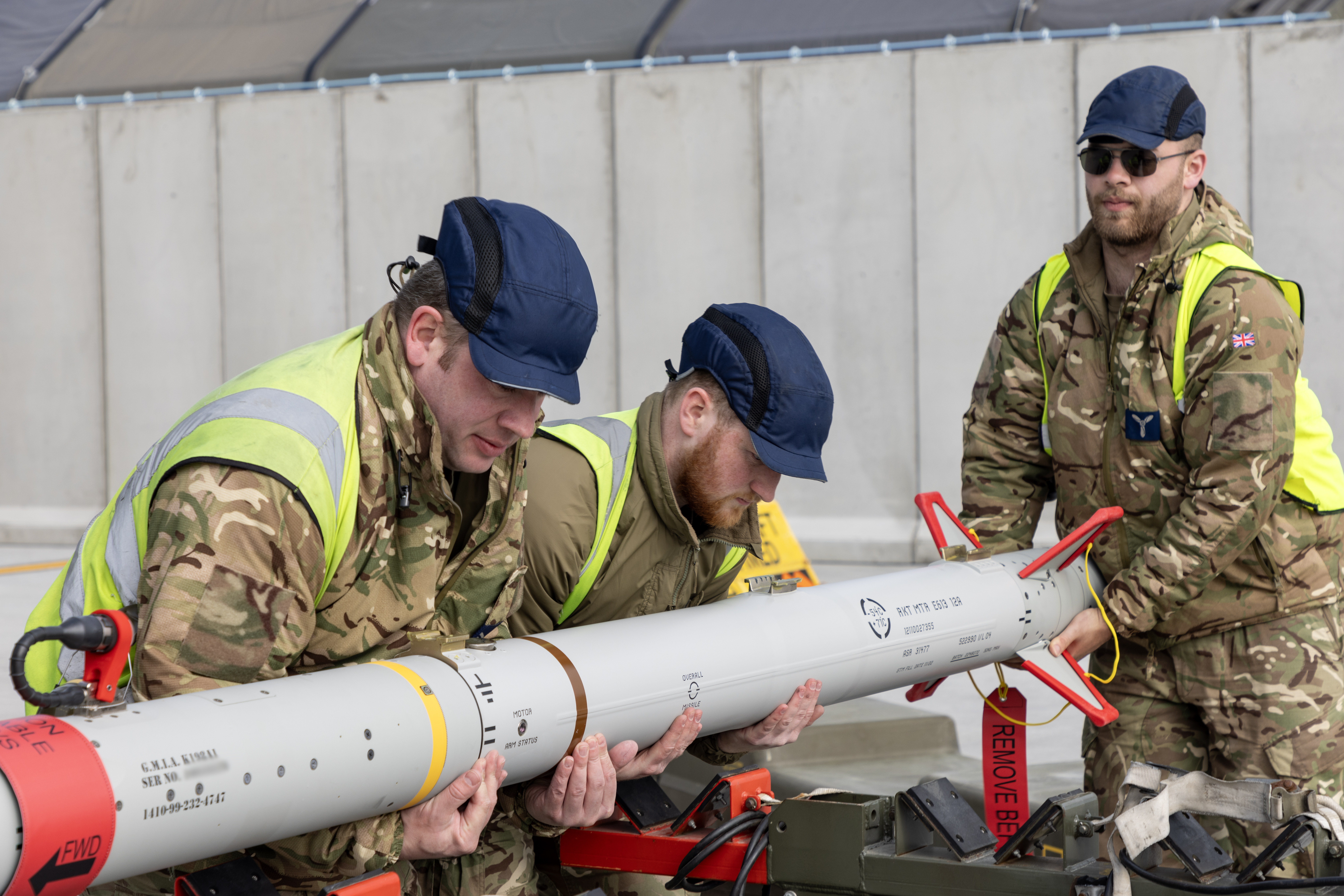 RAF ground crew working together to lift an ASRAAM missile.