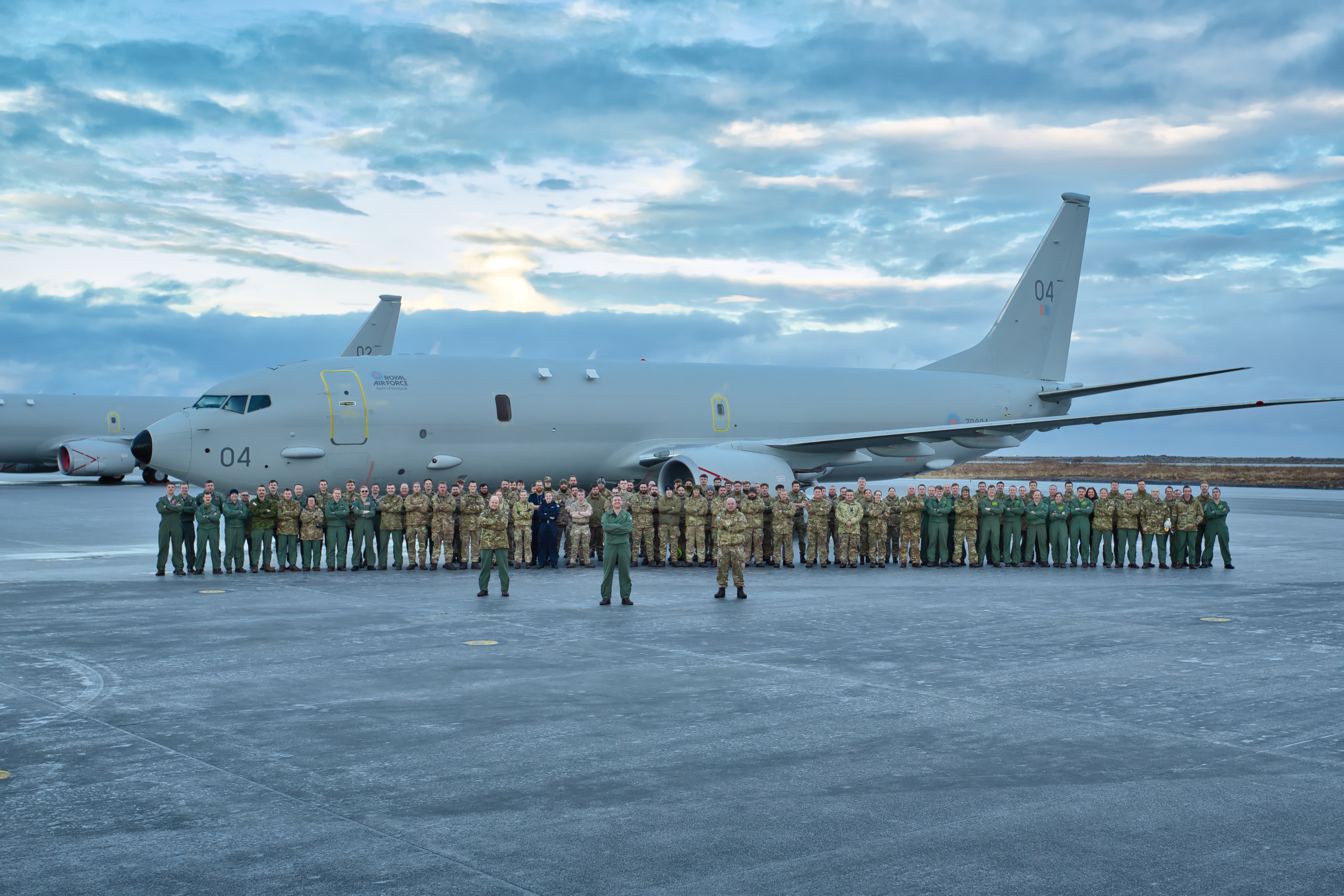 Crews from 120 Squadron stood in front of a P-8A Poseidon in Iceland.