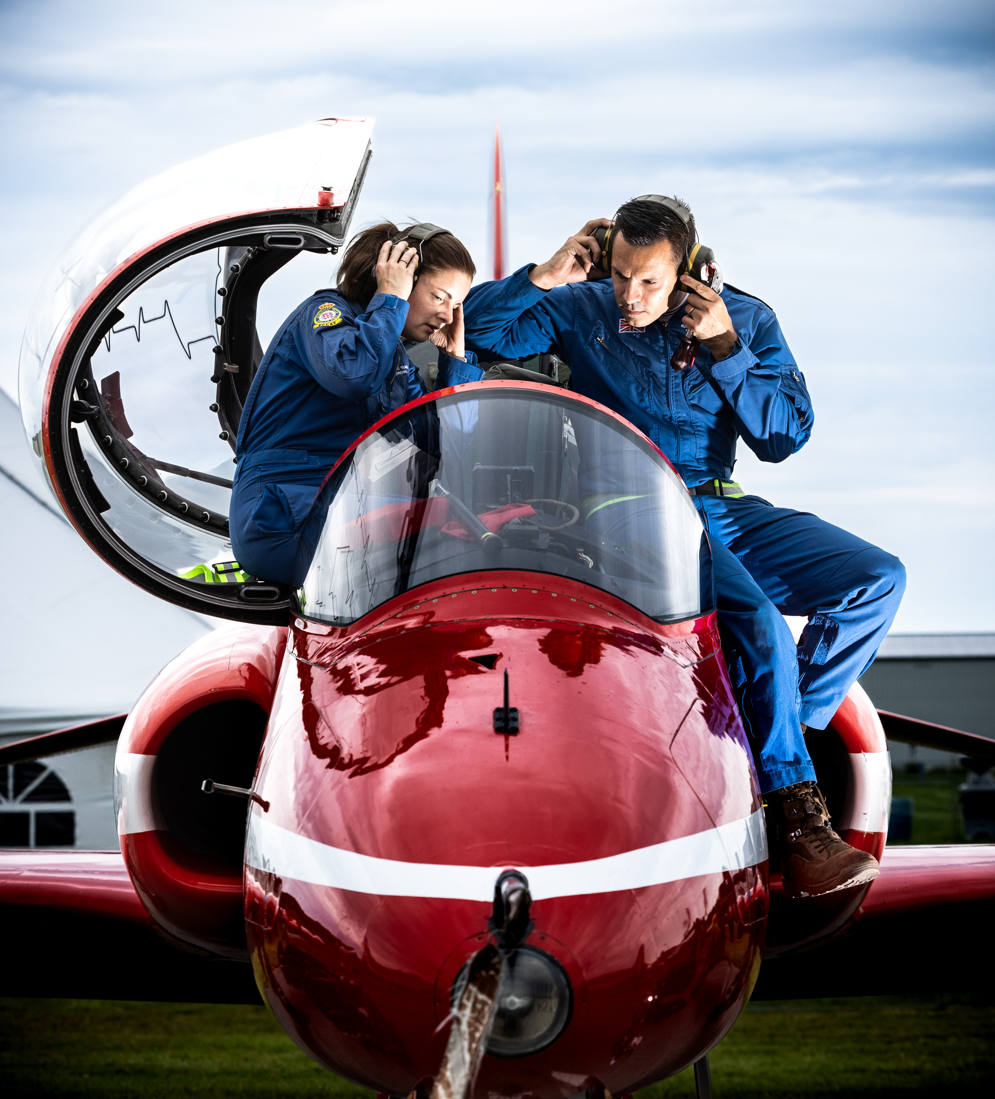Pilots climbing out of cockpit.