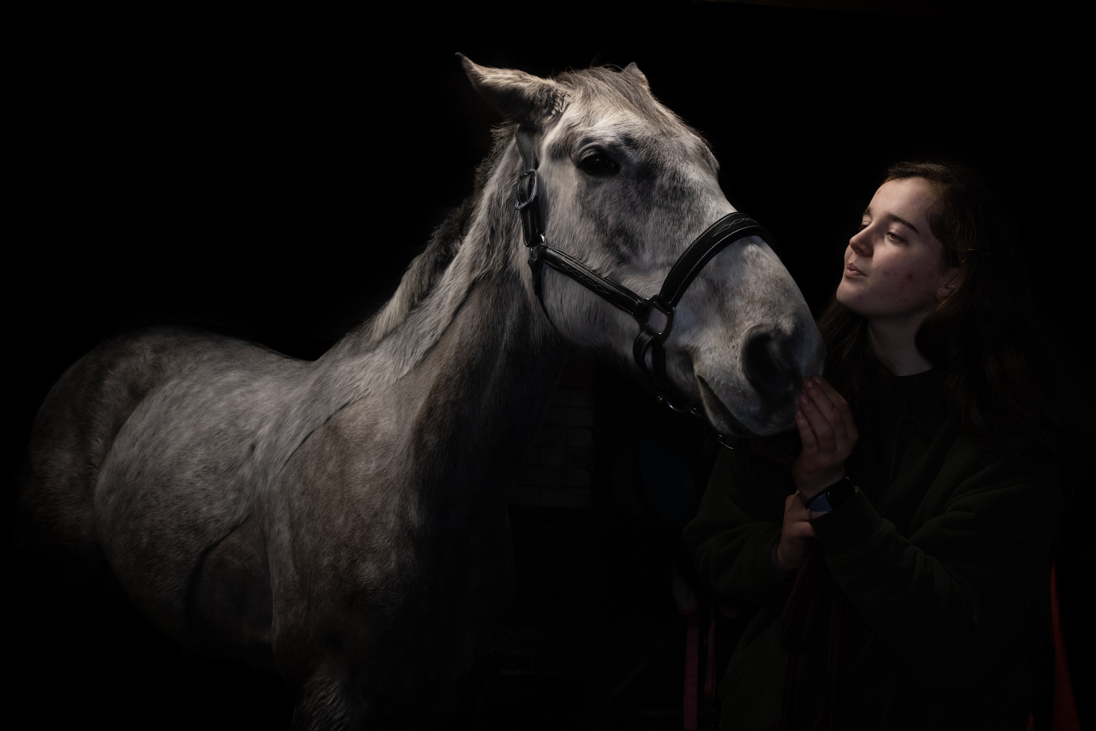 Personnel looking at her horse.
